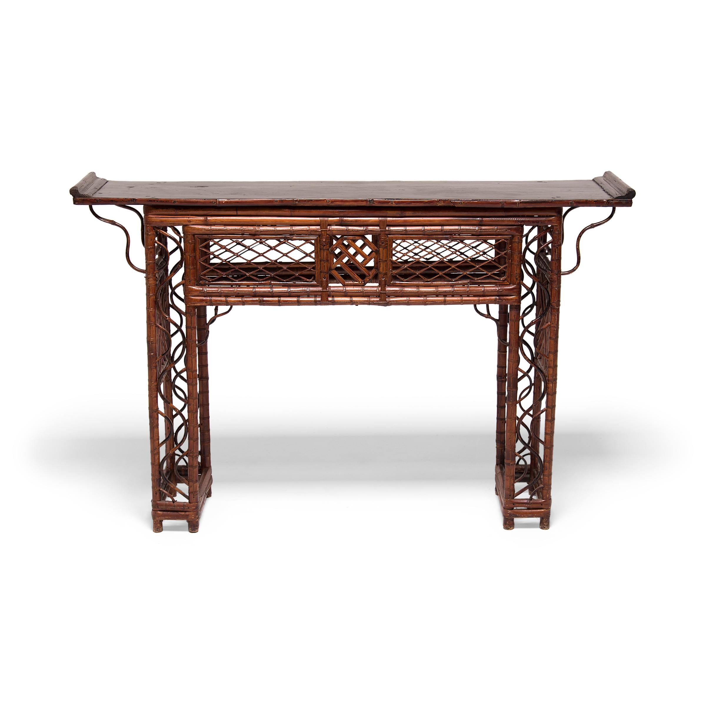 The artisan who created this exquisite lattice altar table must have truly been a master of their craft. Constructed of carefully bent bamboo, the table has a straight, open frame patterned with intricate latticework. The abundant latticework
