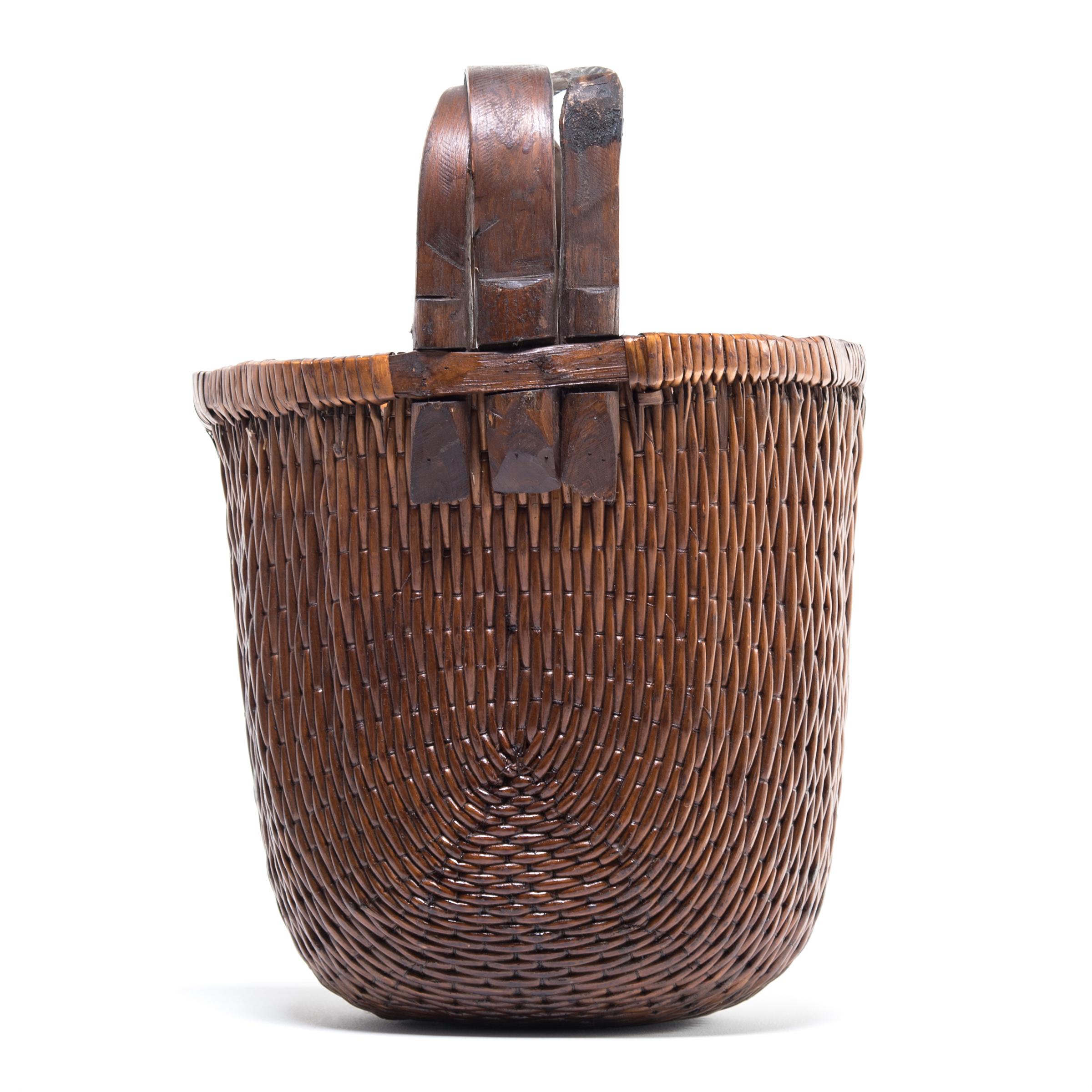 Long ago, someone may have carried this finely crafted bent handle willow basket home from the market everyday: the tightly woven willow strips and strong handle comfortably supporting the weight of their groceries. This basket was made in China and