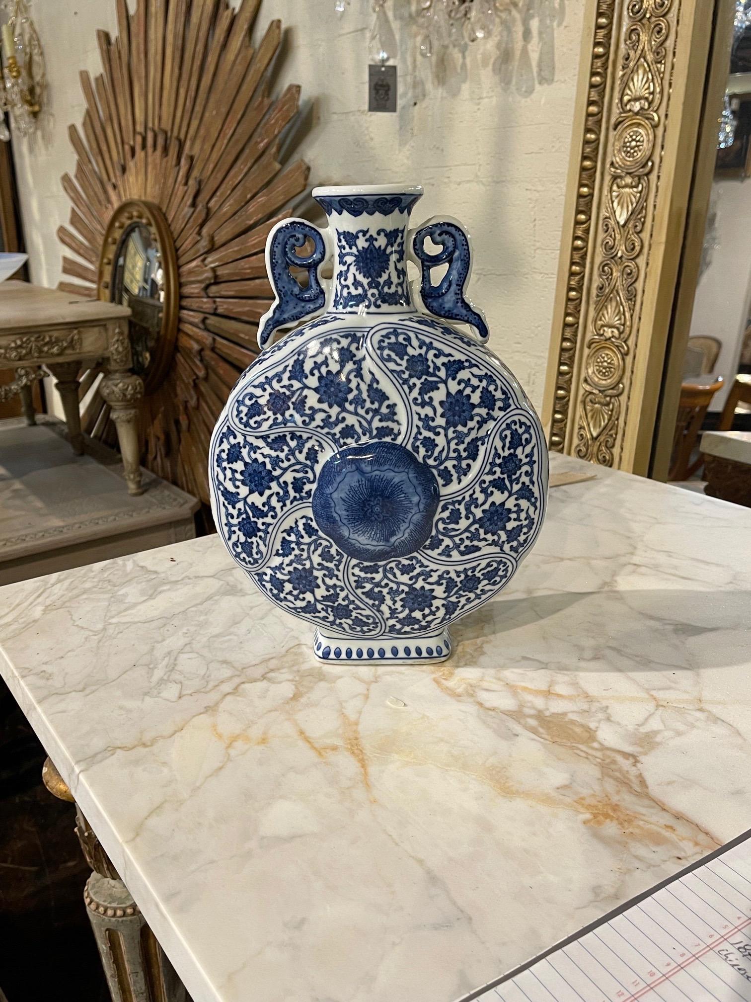 Beautiful early 20th century Chinese blue and white moon flask. Very pretty floral design and interesting shape as well. A fabulous accessory that would make a great gift!