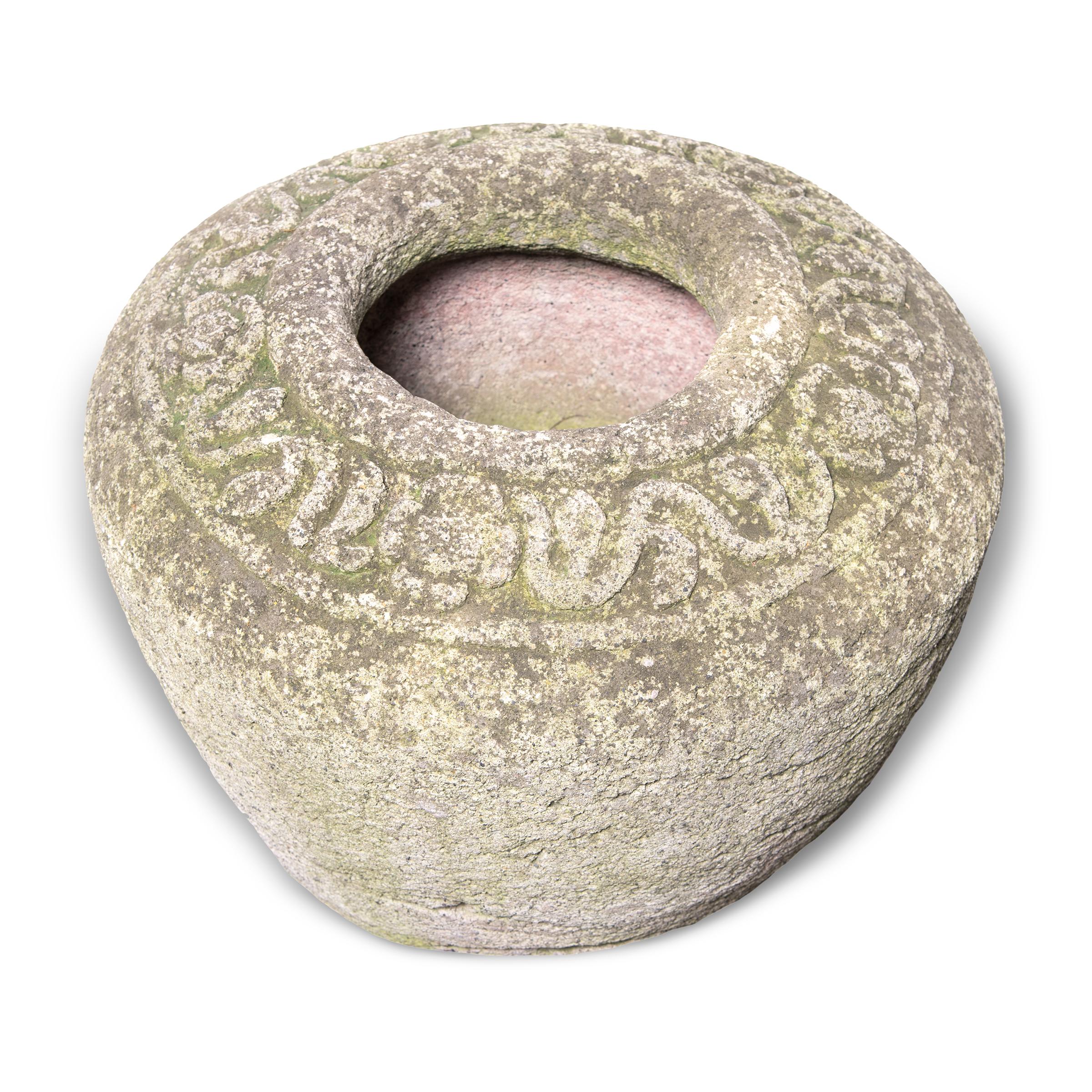 Simply shaped with an elegant form, this large limestone vessel is actually a runner stone, a key component to a traditional Chinese grain mill. Set atop an extensively carved mill stone, the runner stone was harnessed to a donkey or mule that