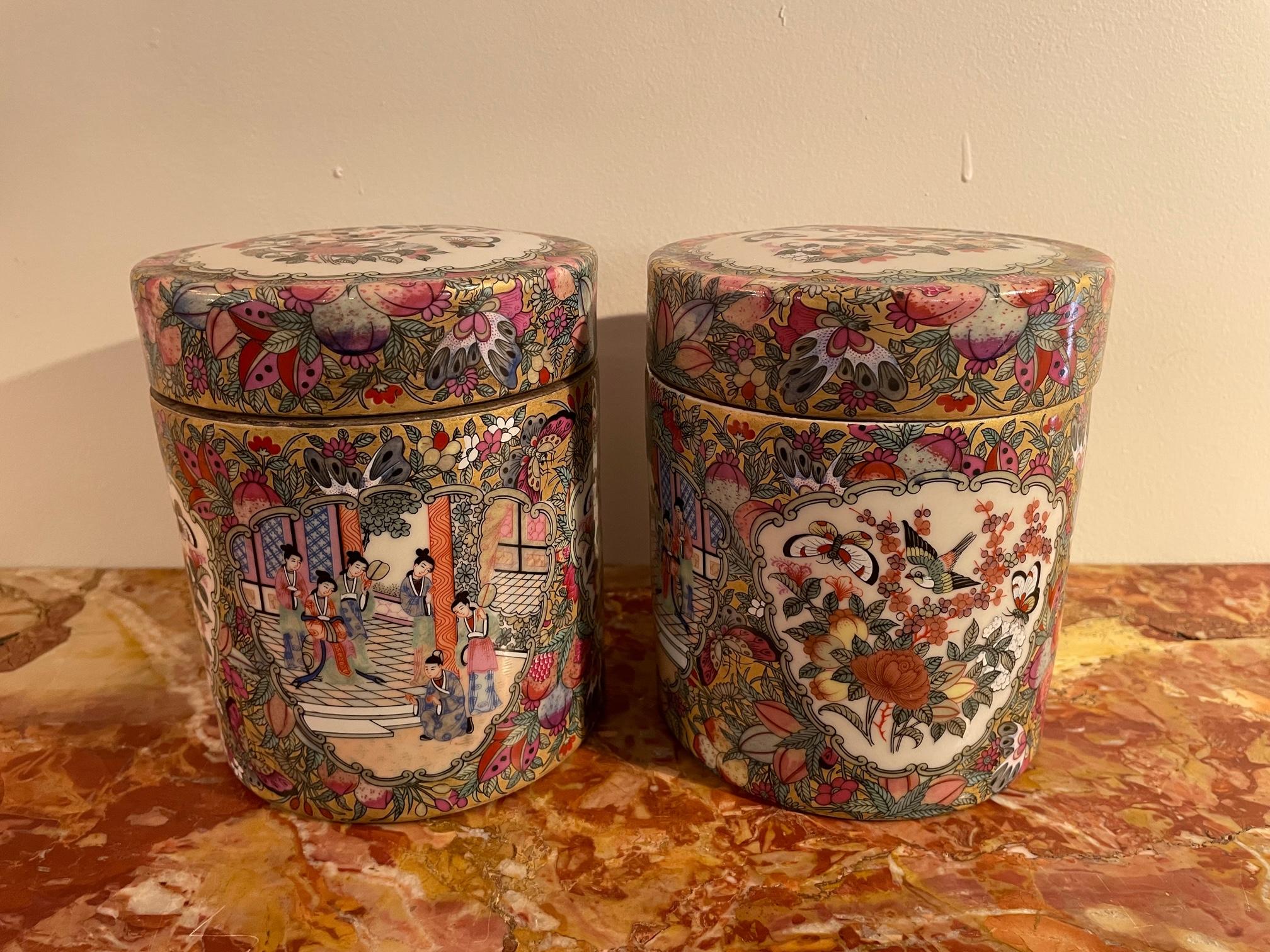 Beautiful pair of Chinese Qianlong Canton porcelain Tobacco Boxe made in the early 20th century. 
Opening top. Stamp of Qianlong underneath. 
Exceptional hand-painted work of Chinese character, flowers, birds and landscapes. 
Very good condition