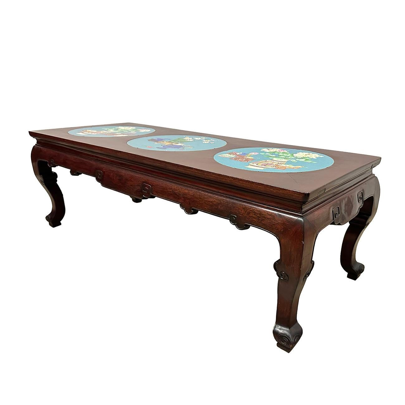 This beautiful Chinese Antique Carved Coffee Table was made from solid hardwood with some traditional carving works on the sides and three cloisonne plates inlayed on the top of the table. This table made at about early 1900's using solid hard wood