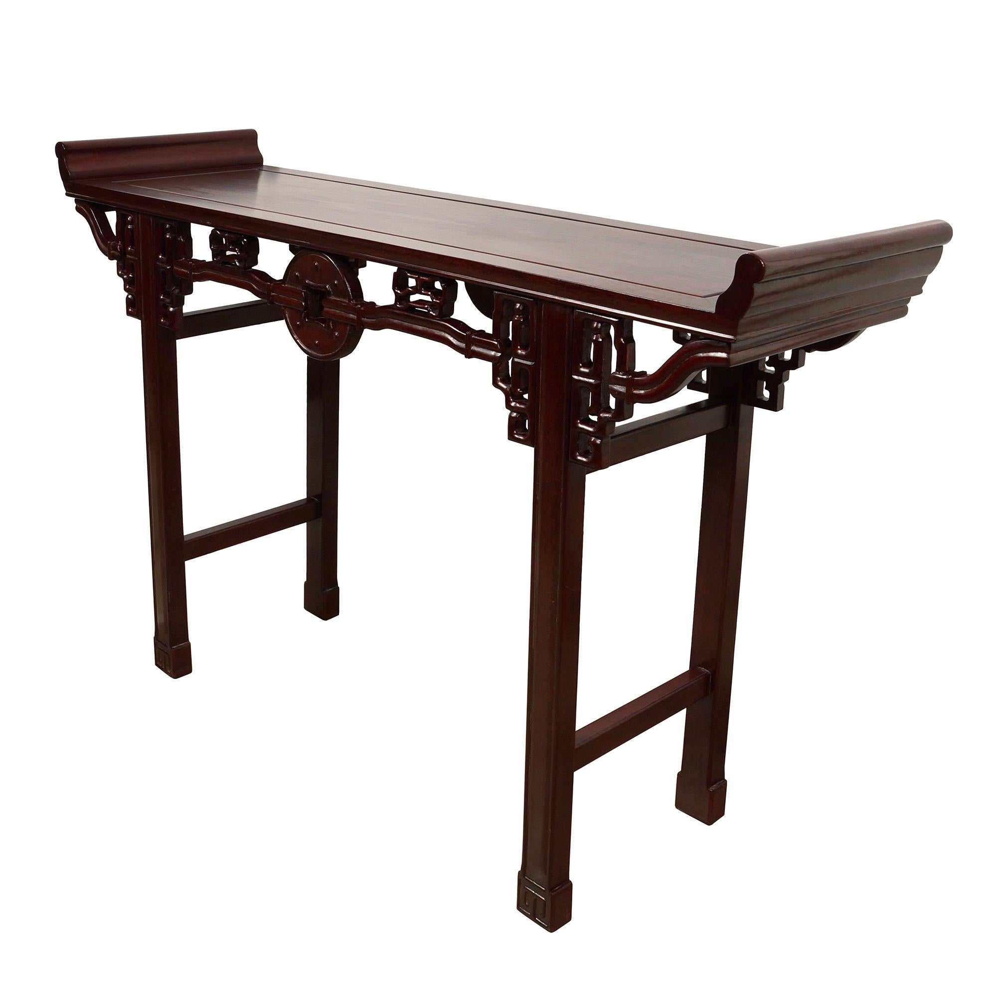 This carved altar table was made from solid Rosewood in about 1900 - 1940's and still maintained very good condition. This table has beautiful open carving works of Chinese traditional folks art design on the both side and the legs. You can use it