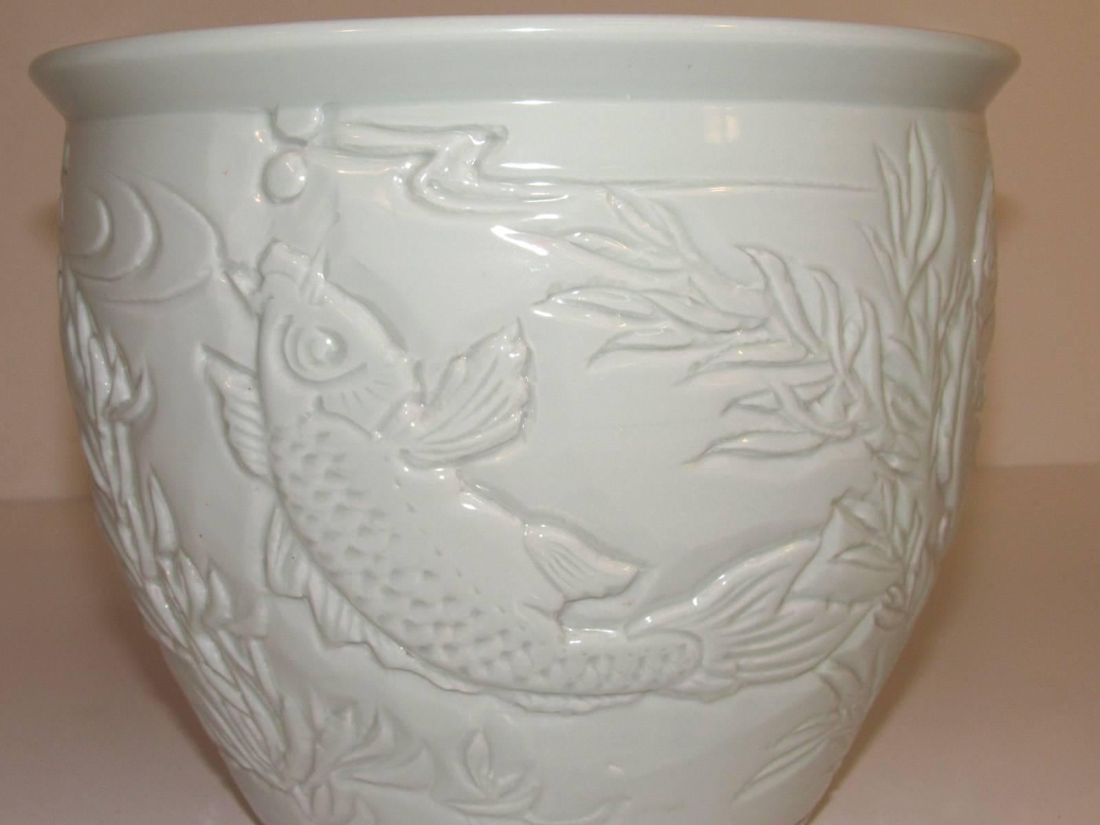 Early 20th century Chinese celadon planter with fish relief.