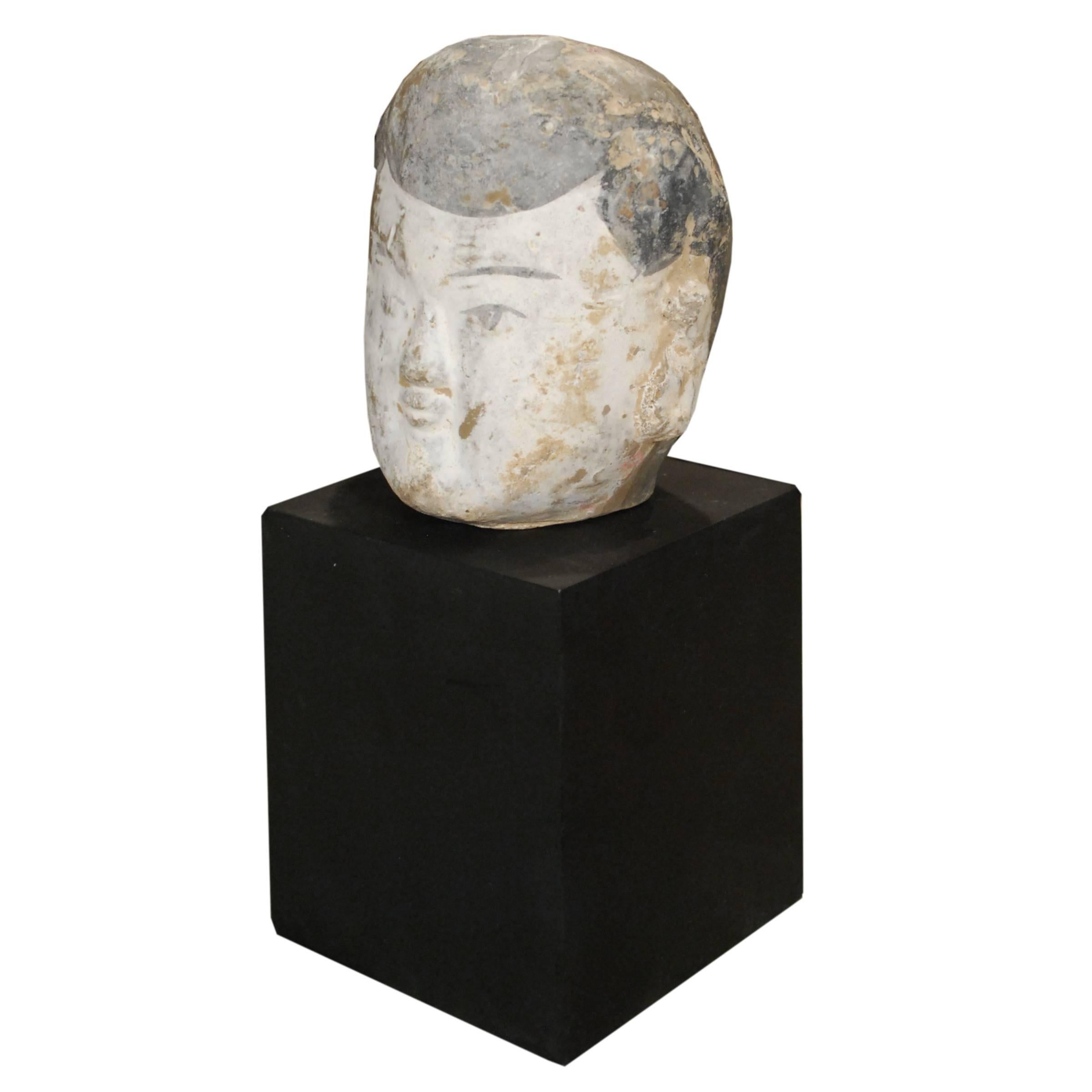 With serene countenance, this sculptural head of a celestial being bears the influence of Tang-dynasty sculpture. Sculptors of this era downplayed pronounced modeling of human features, choosing to create broad shapes and flowing gestures. In