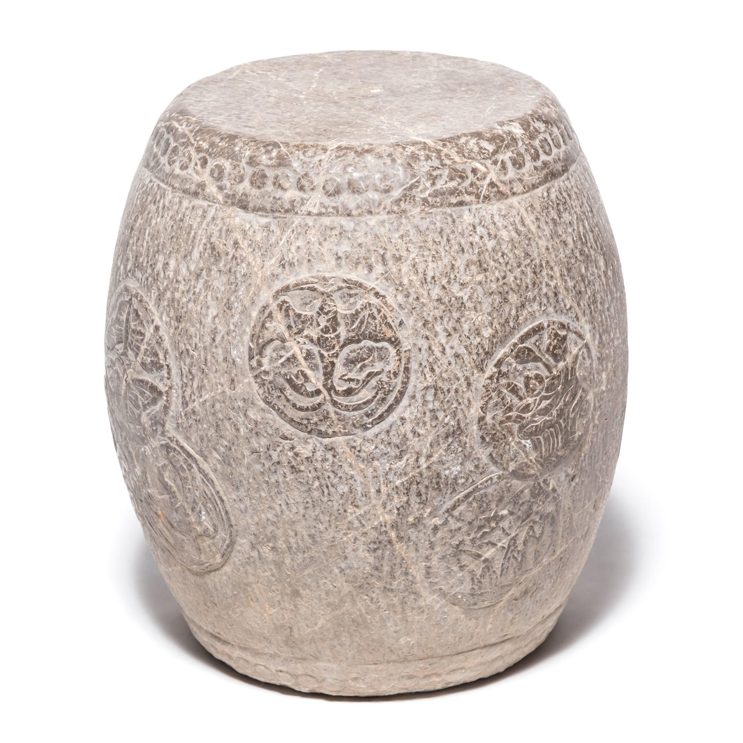 Circular charms adorn the graceful swell of this elegant stone drum stool. An encircled bat symbolizes happiness and joy, while a phoenix represents the spiritual union of yin and yang. Paired butterflies recall an ancient folktale that tells of