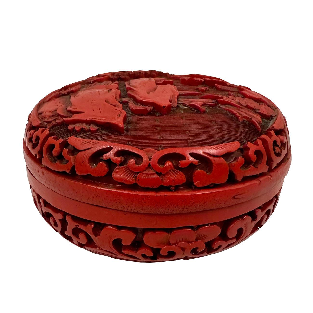 An early 20th Century Chinese cinnabar circular box. This is a marvelous piece with very fine details on the top panel/lid of the box. The top panel is beautifully hand-carved and hand-lacquered with a beautiful scene of mountains and pine trees,