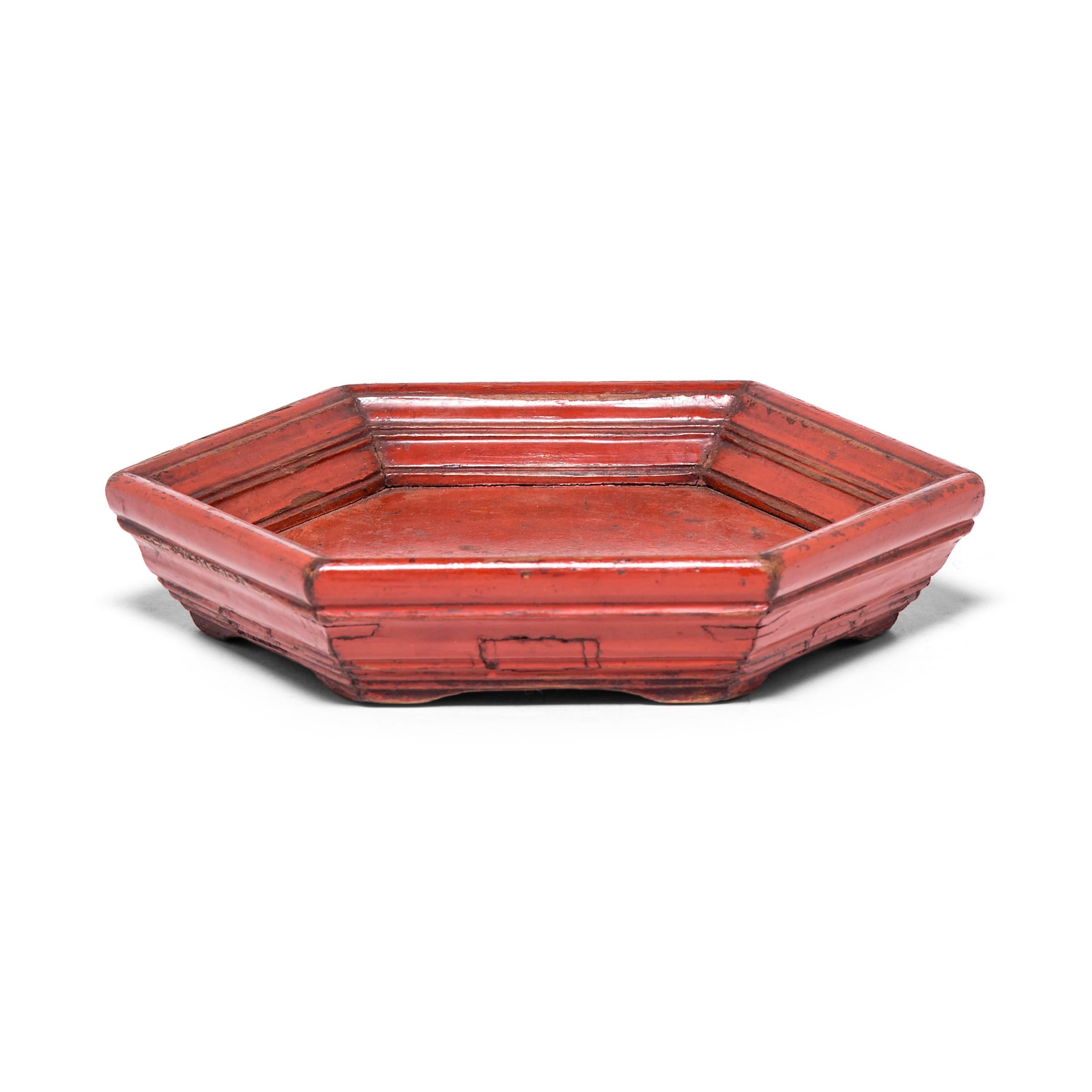 This early 20th century honeycomb tray is bordered by hand carved ridged edges and cloaked in its original cinnabar red lacquer finish, still brilliant after a century of use. The tray was likely presented as a gift to an honored friend, loaded with