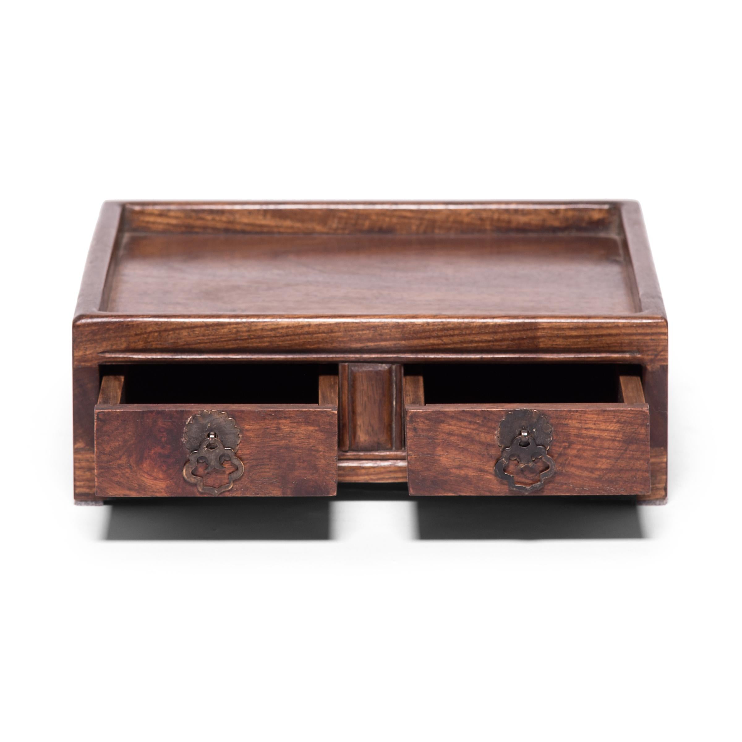 Crafted of a fine hardwood, this early 20th century incense tray is an example of the multi-functional boxes used tabletop in lieu of a chest of drawers. While some were used to store cosmetics, jewelry, documents, and other accessories, the small