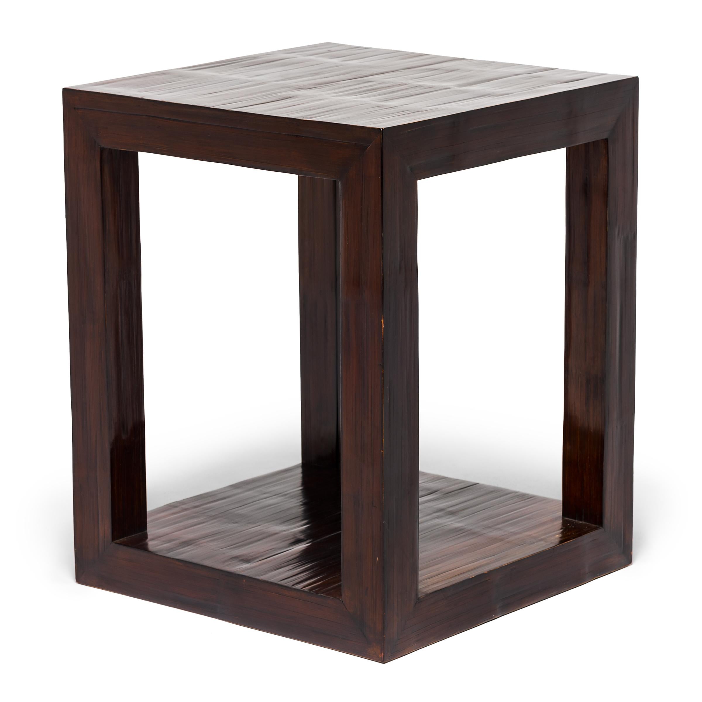 It’s difficult to distinguish this spare pedestal from a modern Parson’s side table. Both exhibit clean lines and a great silhouette. Crushed bamboo brings subtle texture to the Minimalist design, and the dark lacquer brings out its sculptural