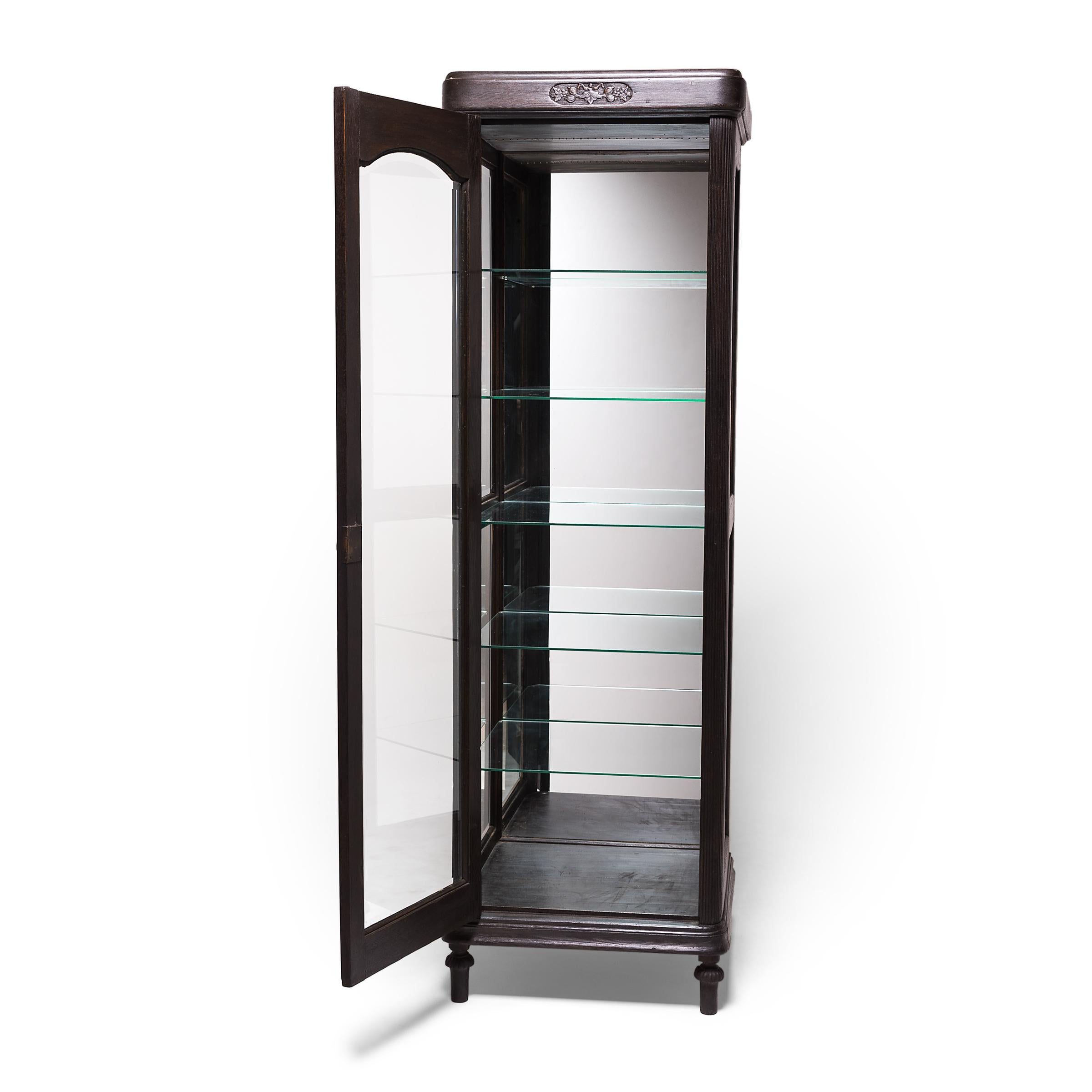 With its distinctly European design, this turn-of-the-century tall shop cabinet was likely commissioned by an expatriate in China, built to display the wealth of consumer goods available in Tianjin, a trade-rich port city in northern China. Crafted