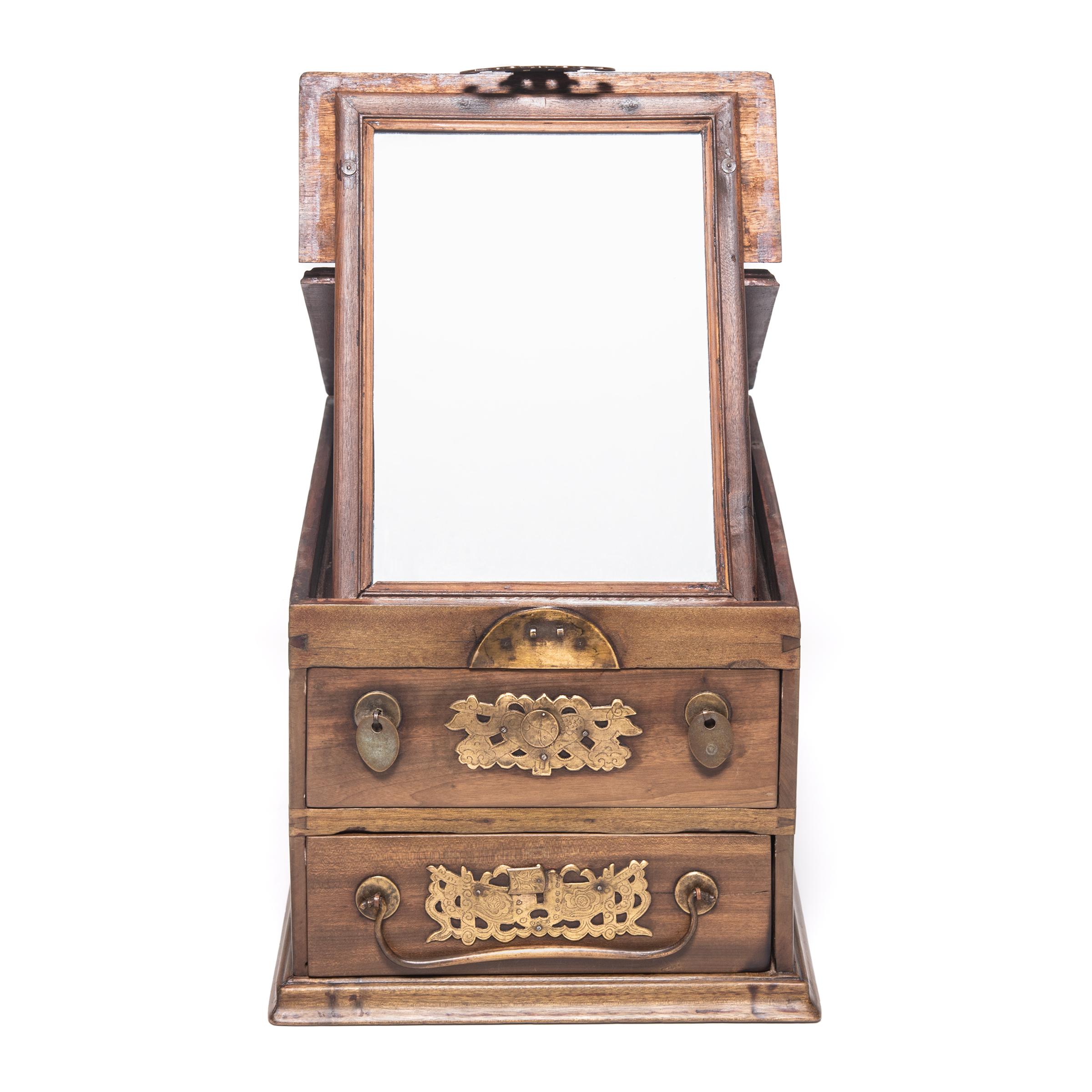 Made in the early 20th century in China's Jiangsu province, this jewelry chest was once used by a Qing-dynasty woman to contain her personal treasures in the intimate quarters of a traditional Chinese home. A latch in the shape of two bats tops the