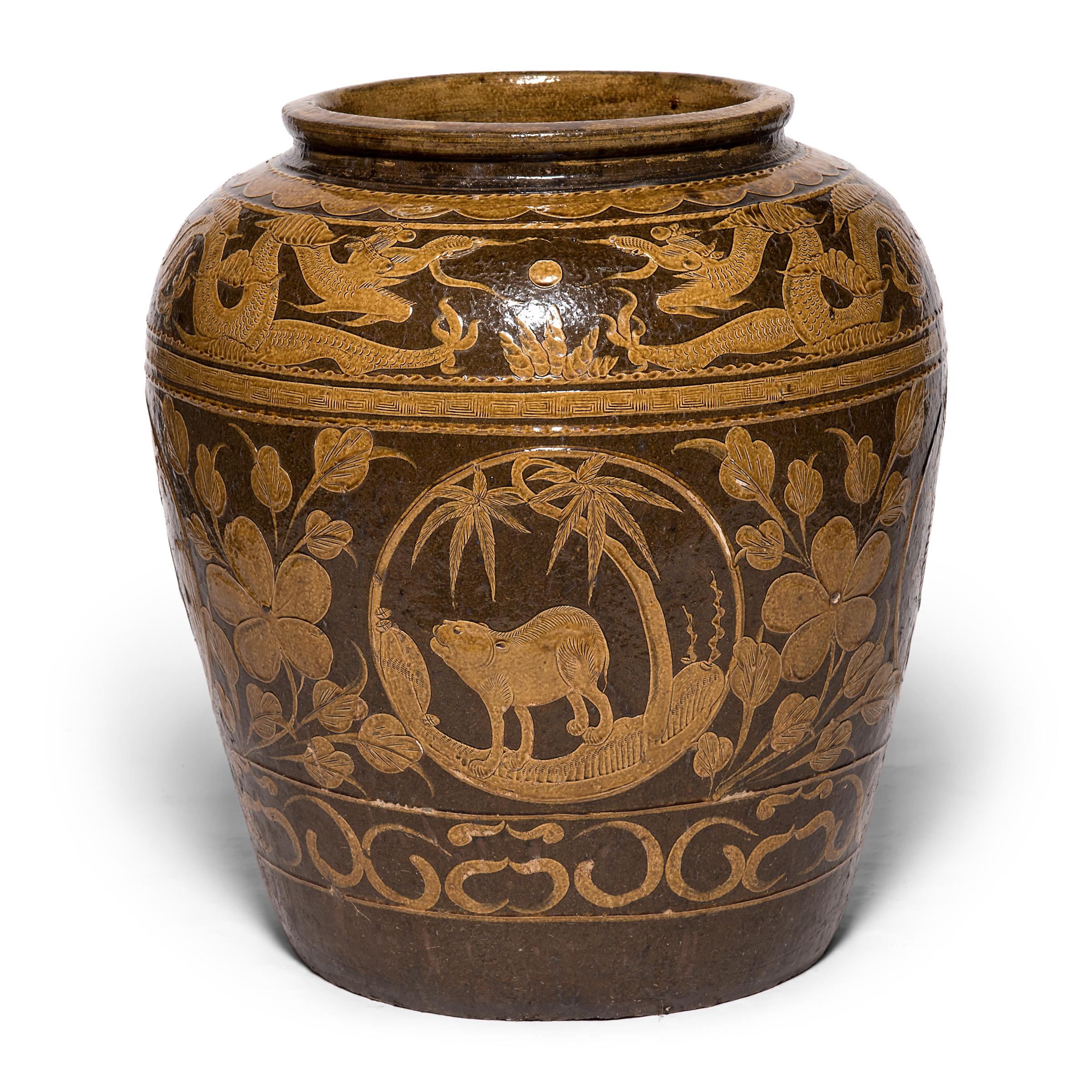 Unlike ceramics decorated with underglazing, this monumental vessel was painted after it was fired. This technique enabled the artist to build up areas and experiment with texture, visible in the stamped pattern along the painted bands and in the