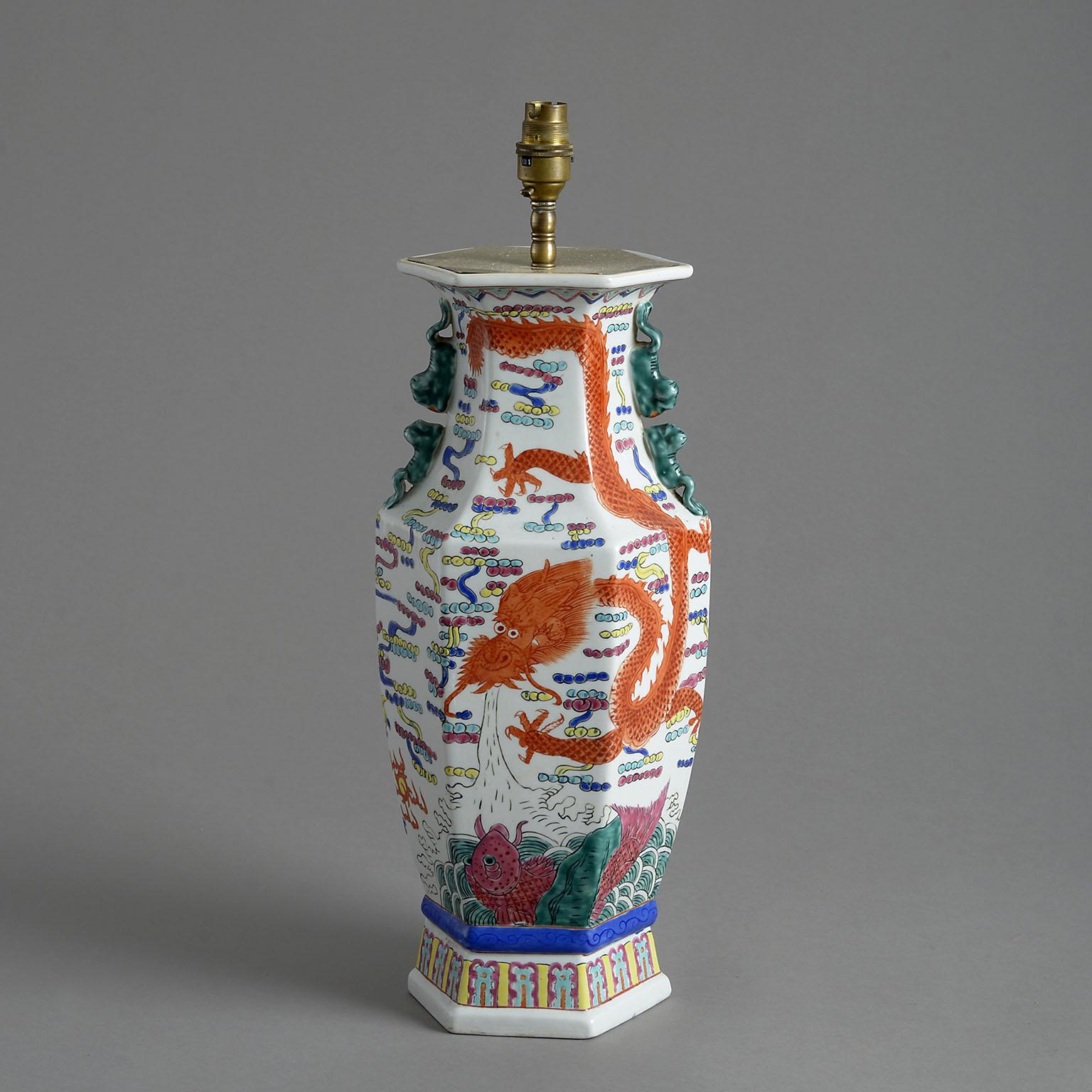 An early 20th century Chinese export porcelain vase of faceted baluster form, decorated with a dragon and carp and now mounted as a lamp base.

Dimensions refer to porcelain parts only.

Display shade not included.

This lamp can be re-wired