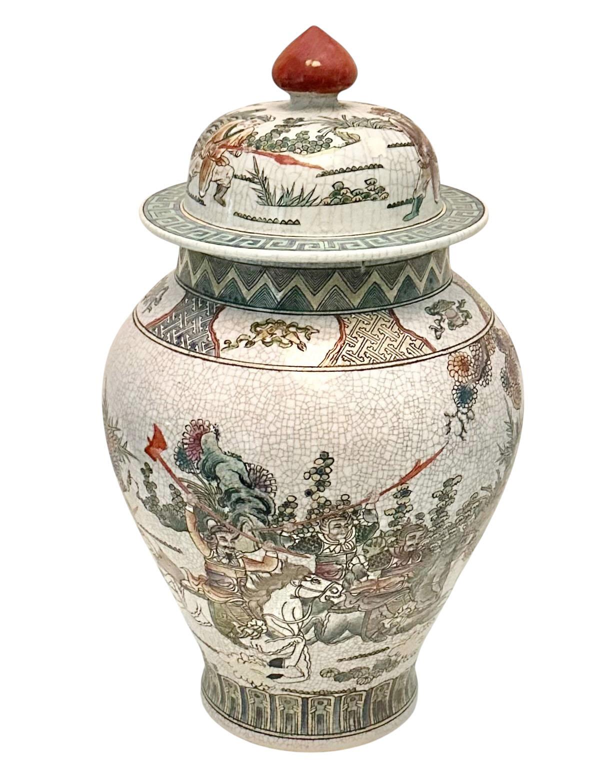 A striking Chinese Famille Verte porcelain vase, vividly hand painted with an animated battle scene featuring warriors on horseback in full motion, clashing amidst swirling banners and weaponry. The composition is dynamic and detailed, capturing