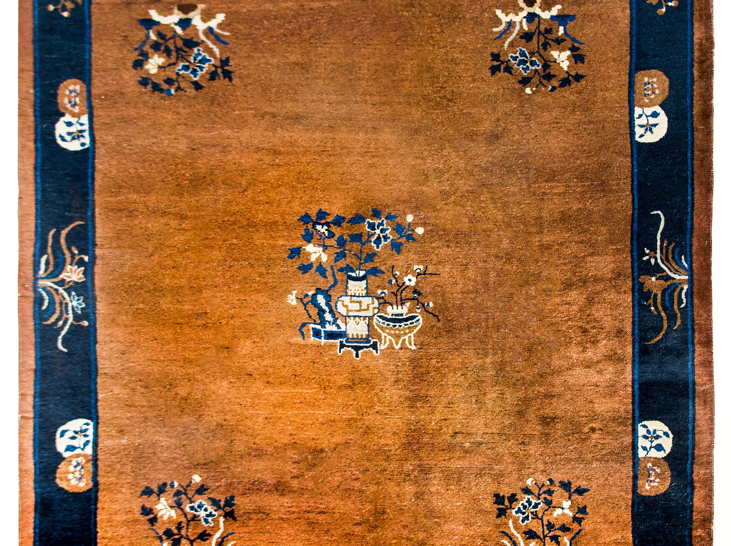 A stunning early 20th century Chinese Feti rug with a chic brown, white, and indigo color palette woven with a large central medallion containing a vase potted with peonies, and a large peony in each corner. The border contains several more stylized