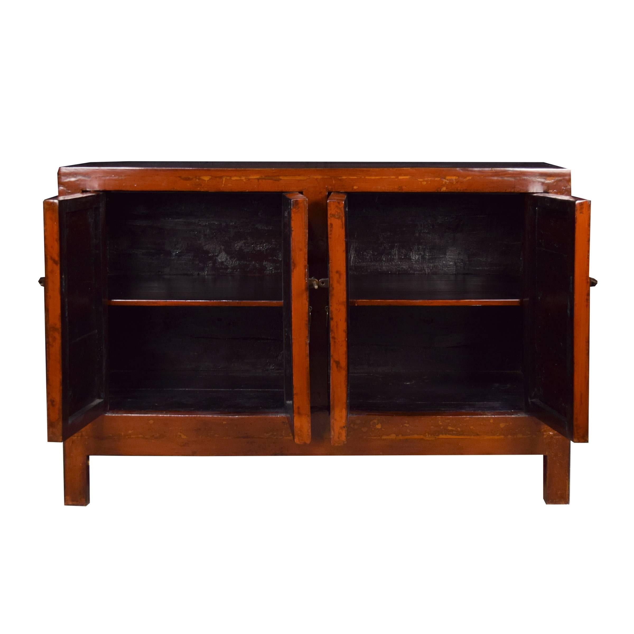 This 19th century chest, hailing out of Northern China, started its life as a storage trunk with a solid lacquered front. Our artisans, skilled in traditional Chinese carpentry and lacquer finishes, reconfigured it into a four-door chest; brushing