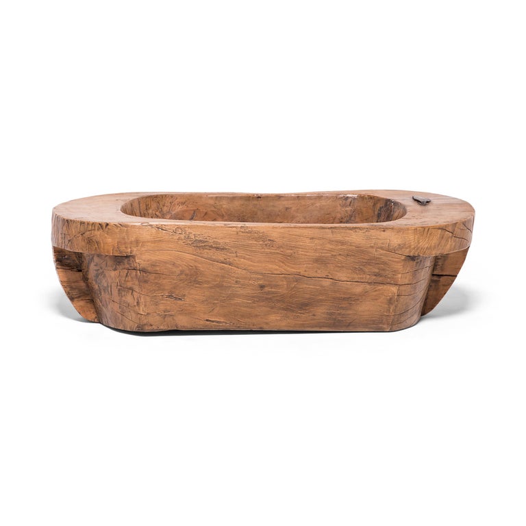 Hand carved from a single piece of wood, this oblong basin has fantastic character. Once used to hold grain as a part of the threshing process, the early 20th century tub displays the warmth of oakwood, now beautifully aged with a rich patina. The