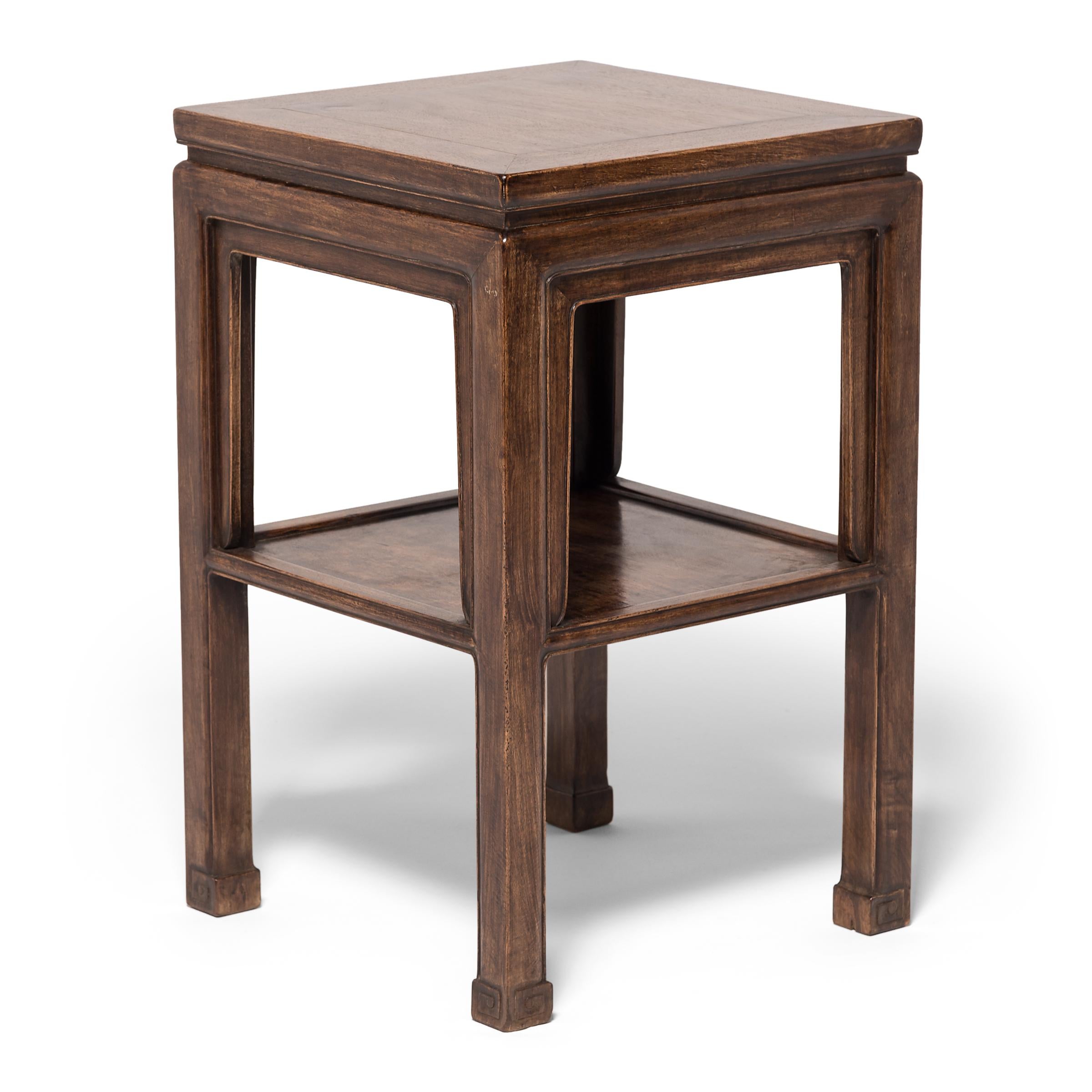 This early 20th century table is made of huali wood, a type of rosewood, and was likely used as a display stand for flowers or antiquities. Its subtle elegance is in the details: a petite waist, tailored apron, and legs ending in scroll-carved feet.
