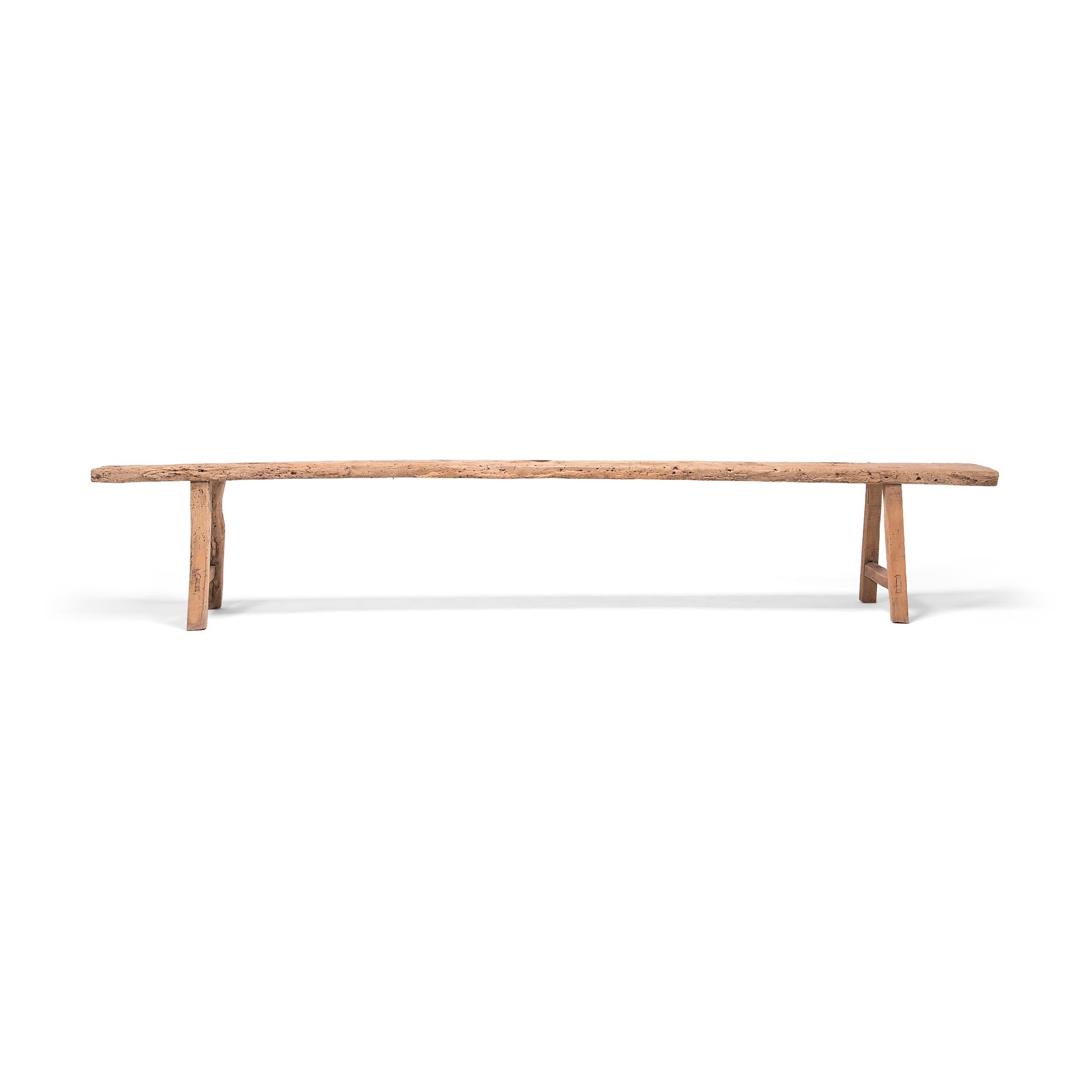 This long, narrow bench exemplifies rustic style with its simple design and wonderfully aged surface. Crafted by anartisan in China's Shanxi province, the bench would have been used as versatile seating along a hútòng, the meandering walkway linking