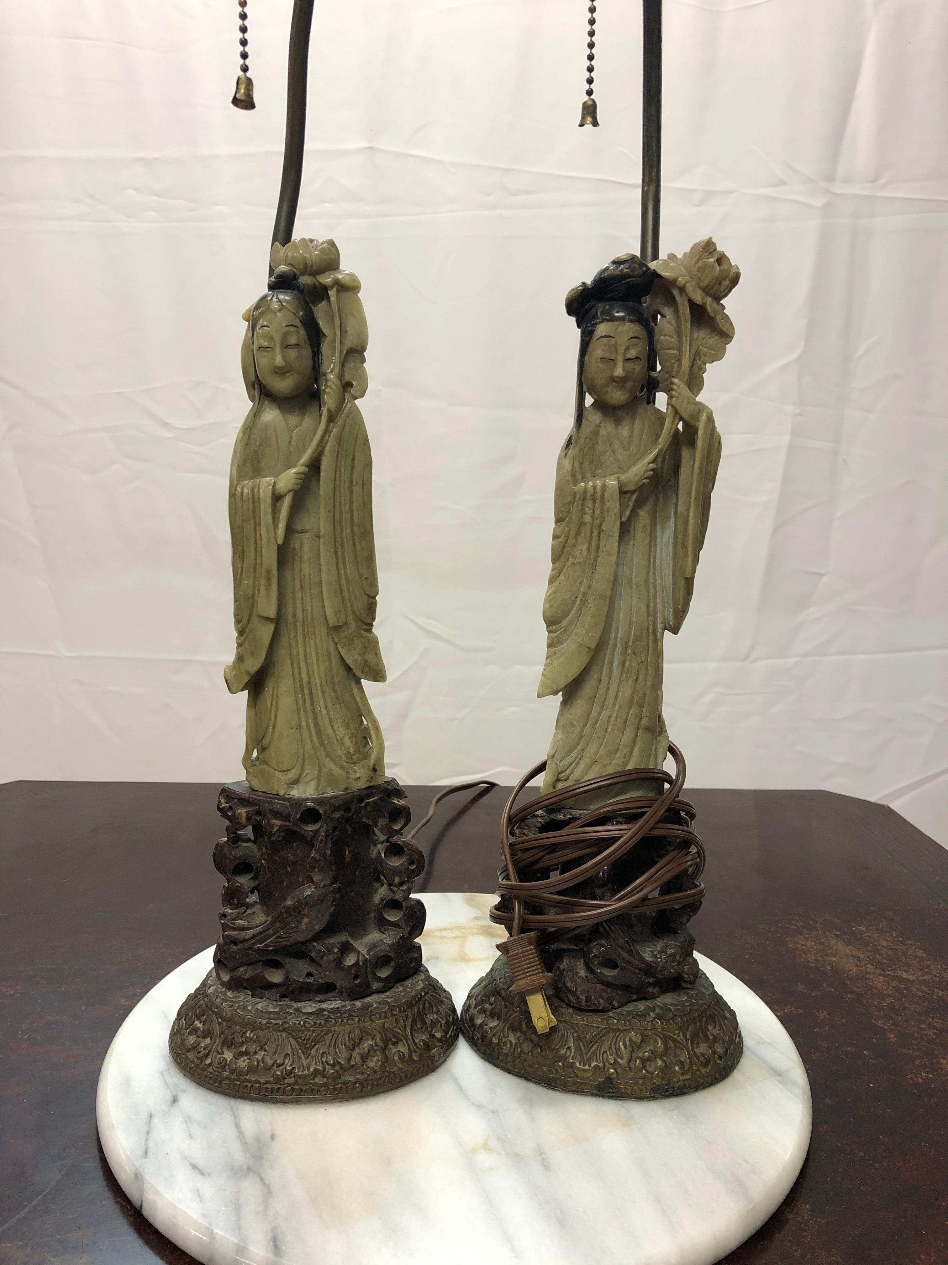 Fabulous pair of early 20th century hardstone Chinese figural lamps. The finials are jade and come with the original silk shades. They measure 12 1/2 inches high with the base and 11 1/2 without. Each lamp is approximately 16 inches wide.