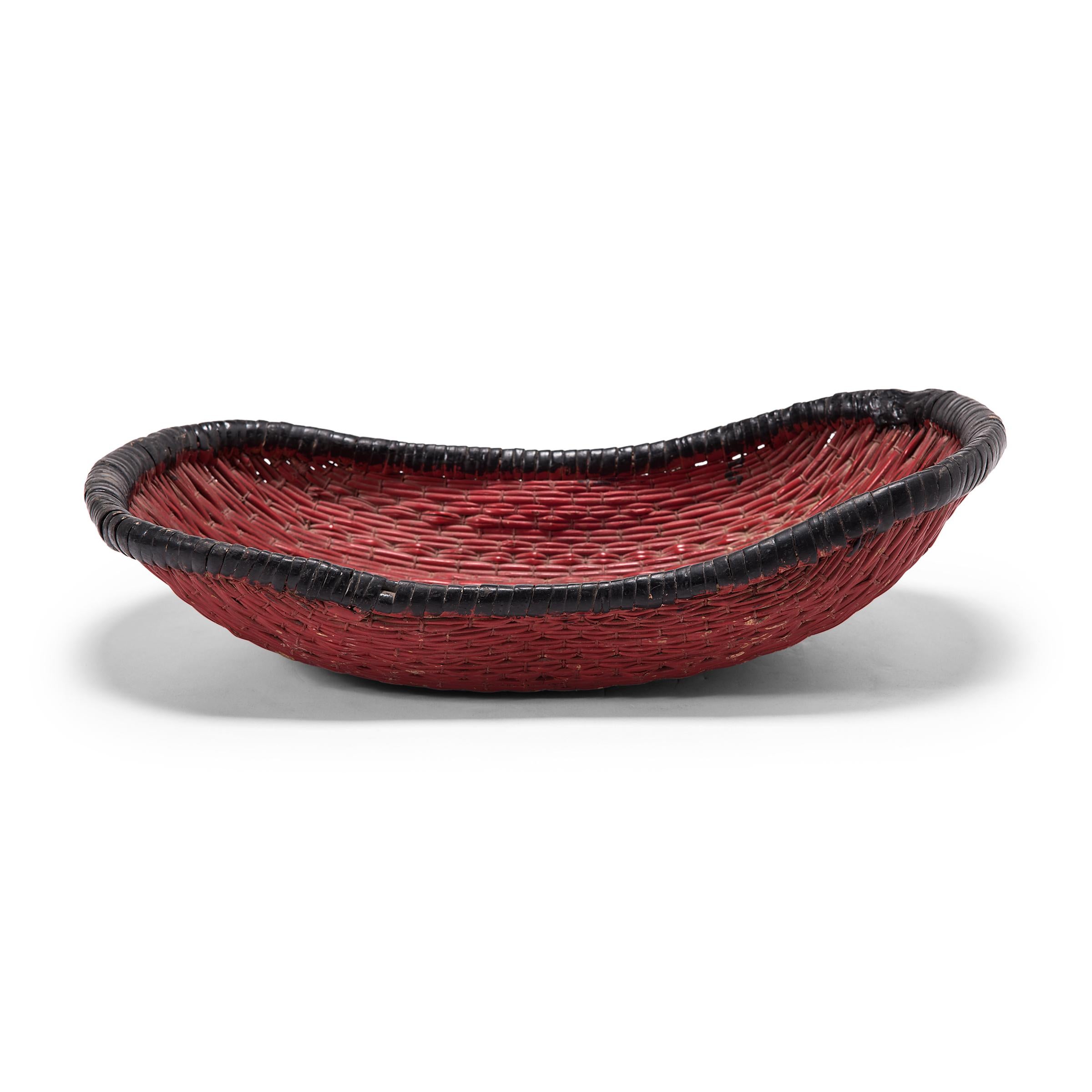 Woven with a delightfully unusual form, this early 20th century basket was originally used to steam mantou buns in a Provincial home in Shanxi province. The boat-shaped basket is formed of willow reeds entwined with a plain weave, and has since been