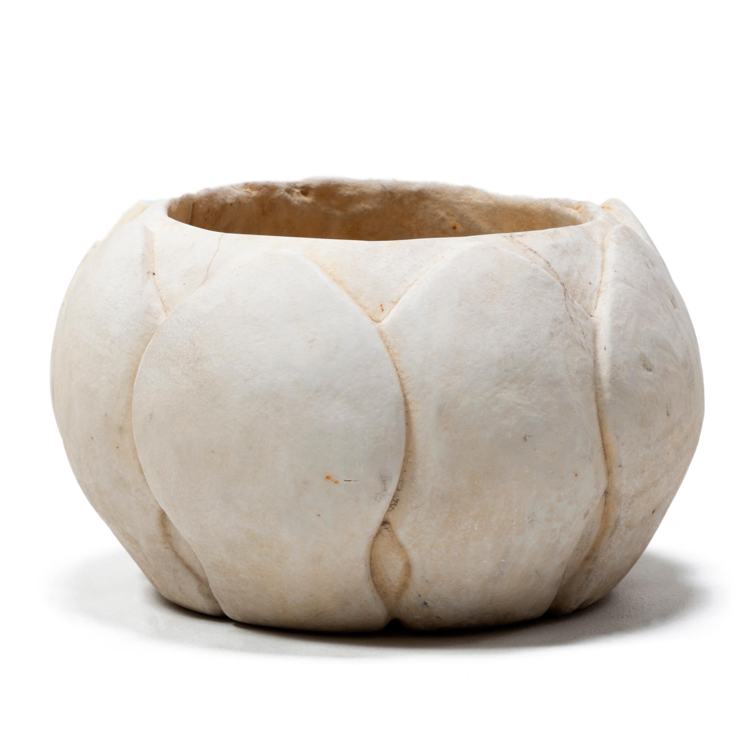 This 20th century basin was hand carved from solid marble into the form of a blossoming lotus flower. Emerging from the mud of riverbanks yet pristine and beautiful, the lotus plant is a symbol of purity and perfection, and is considered a sacred