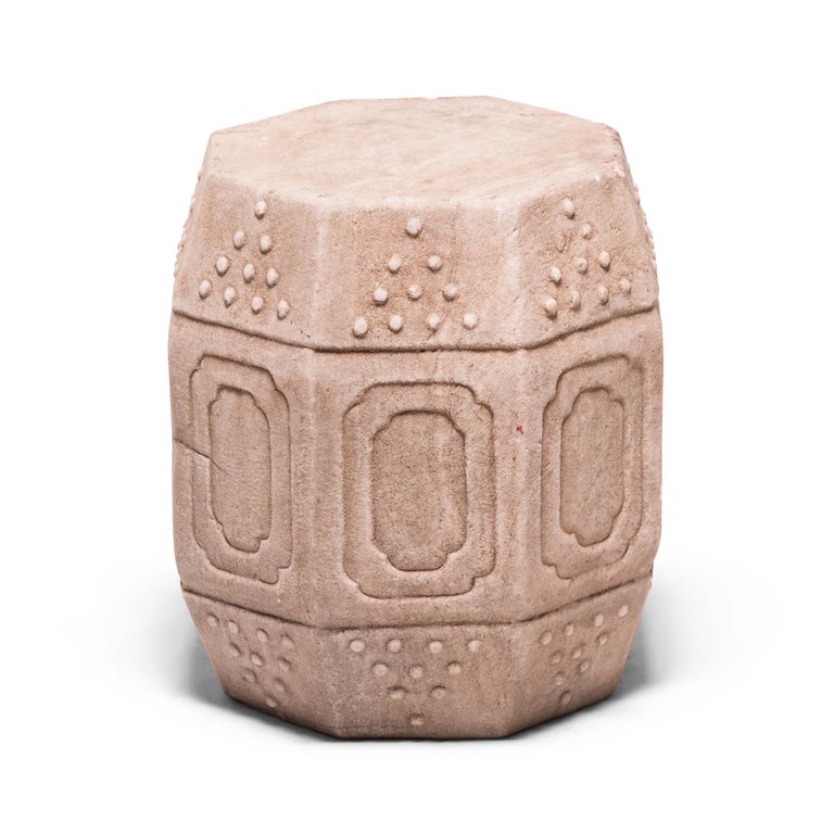Hand carved of solid marble in China's Hebei province, this early 20th century drum-form stool has eight sides, an auspicious number symbolizing good fortune and prosperity. Each side is decorated with a simple yet effective design of nested
