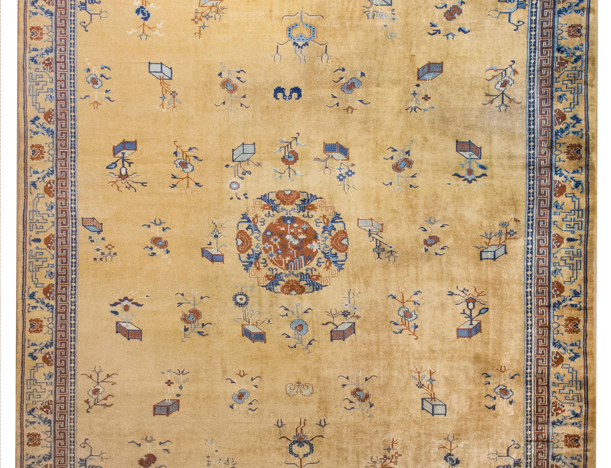 A rare and exquisite early 20th-century Chinese Peking rug, distinguished by its luminous gold field—a sought-after hue that adds warmth and depth. At its heart, a central medallion blooms with stylized cherry blossoms and peonies, symbols of