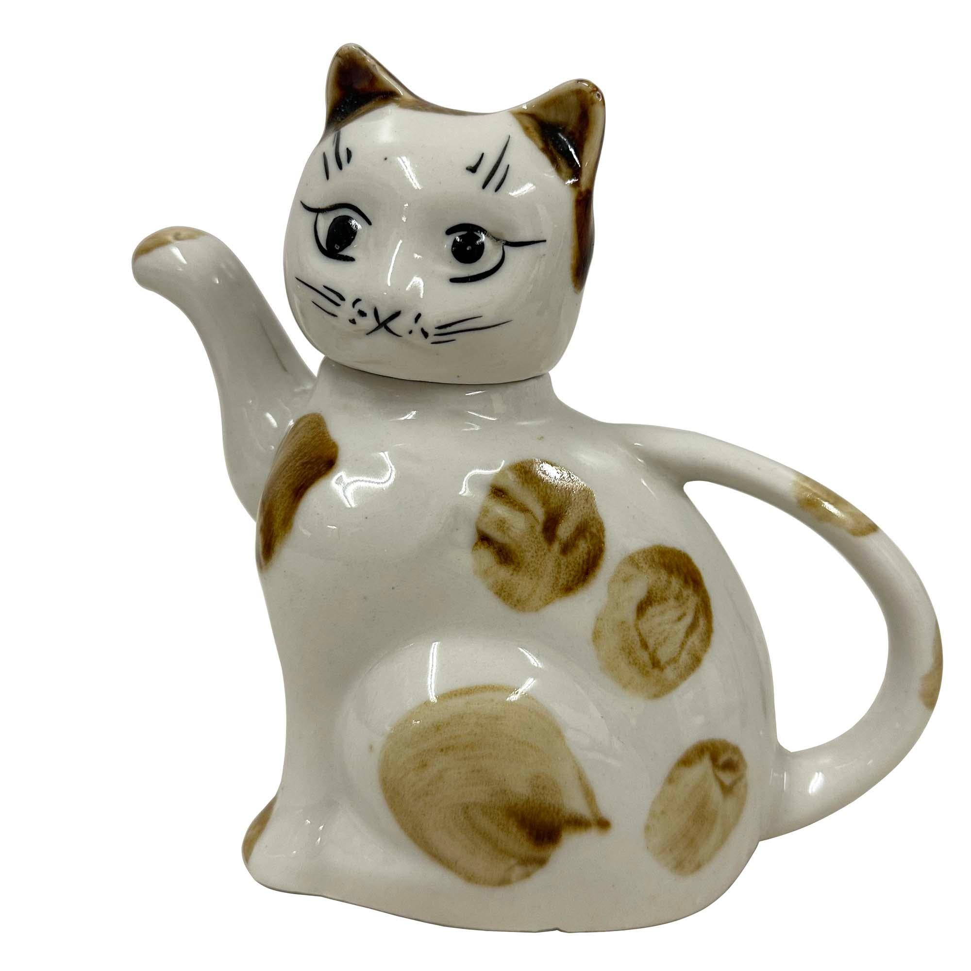 This Porcelain Cat teapot is well made in China in about 1930s, Chinese republic era.  It purpose to make hot tea.  This raised paw cat teapot is typically in Late Qing dynasty or early Republic era. The cat head is removable as the teapot lid. It