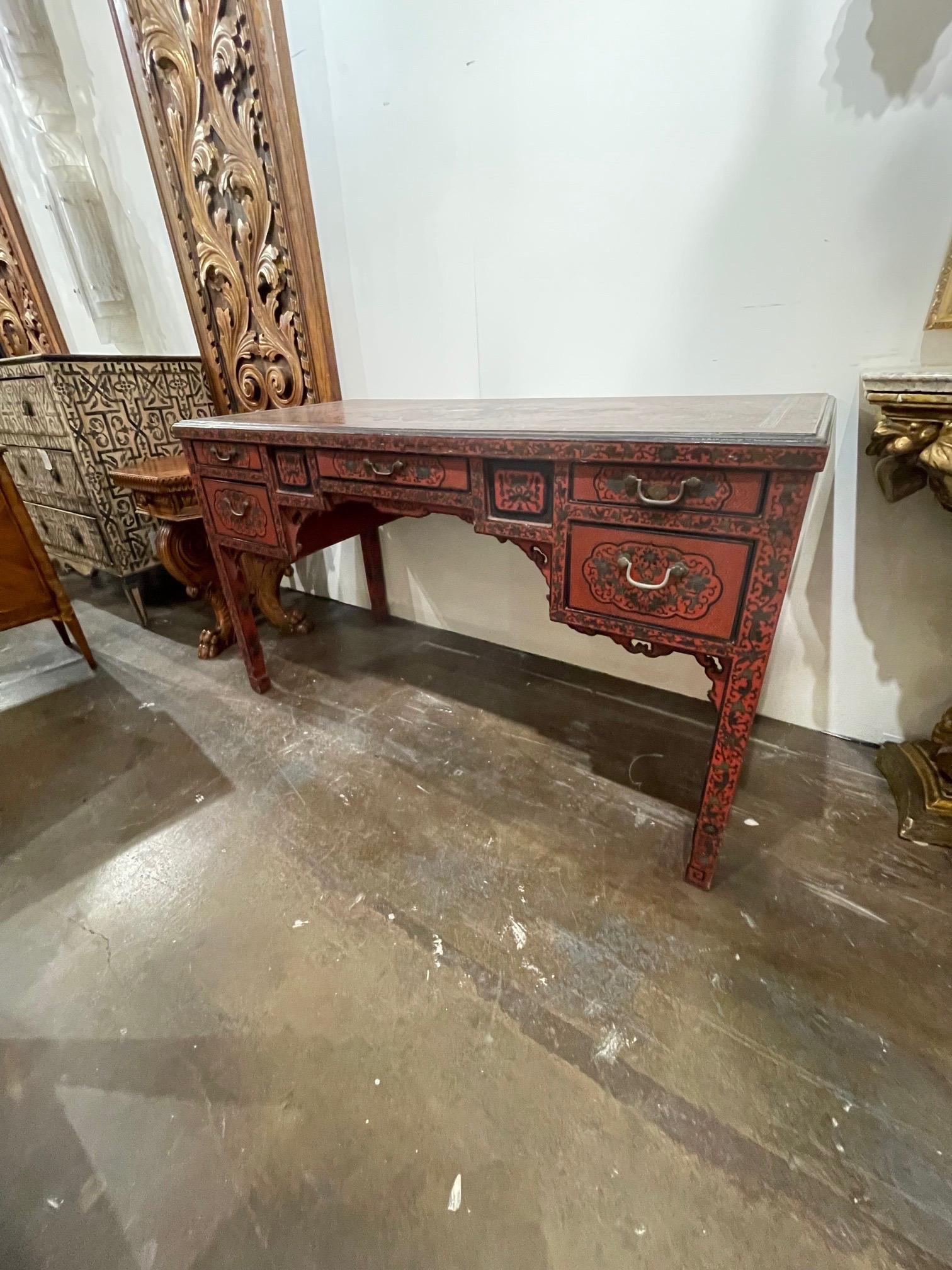 Decorative early 20th century Chinese red and black lacquered writing desk. Gorgeous painted patterns and Asian images. So unique! An exceptional piece!.