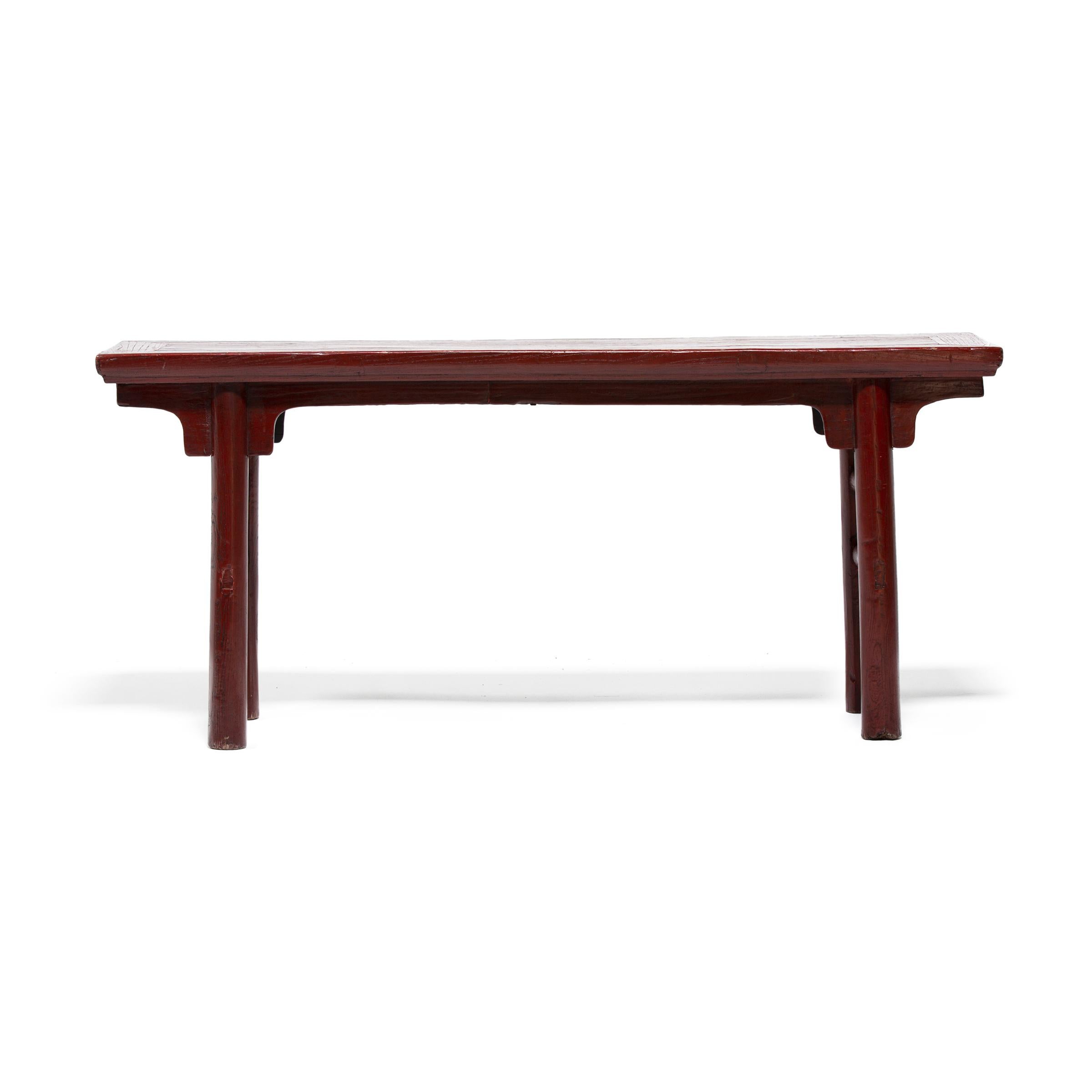 This low, early 20th century gate bench would have originally resided in the courtyard of a Qing-dynasty home to provide much-needed outdoor seating on hot summer days. The bench is designed in a classical Ming style, with a floating panel top,