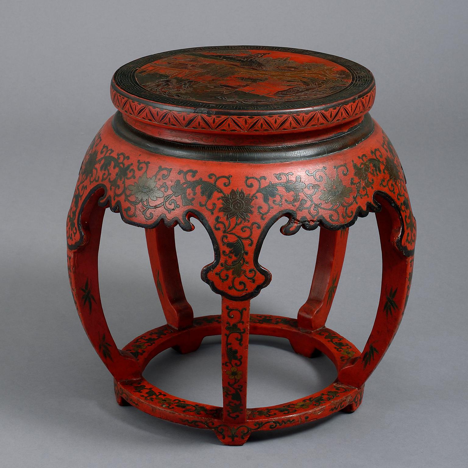 An early 20th century Chinese lacquer low table or stool with circular top and curved supports, decorated on a sealing-wax red ground.

  