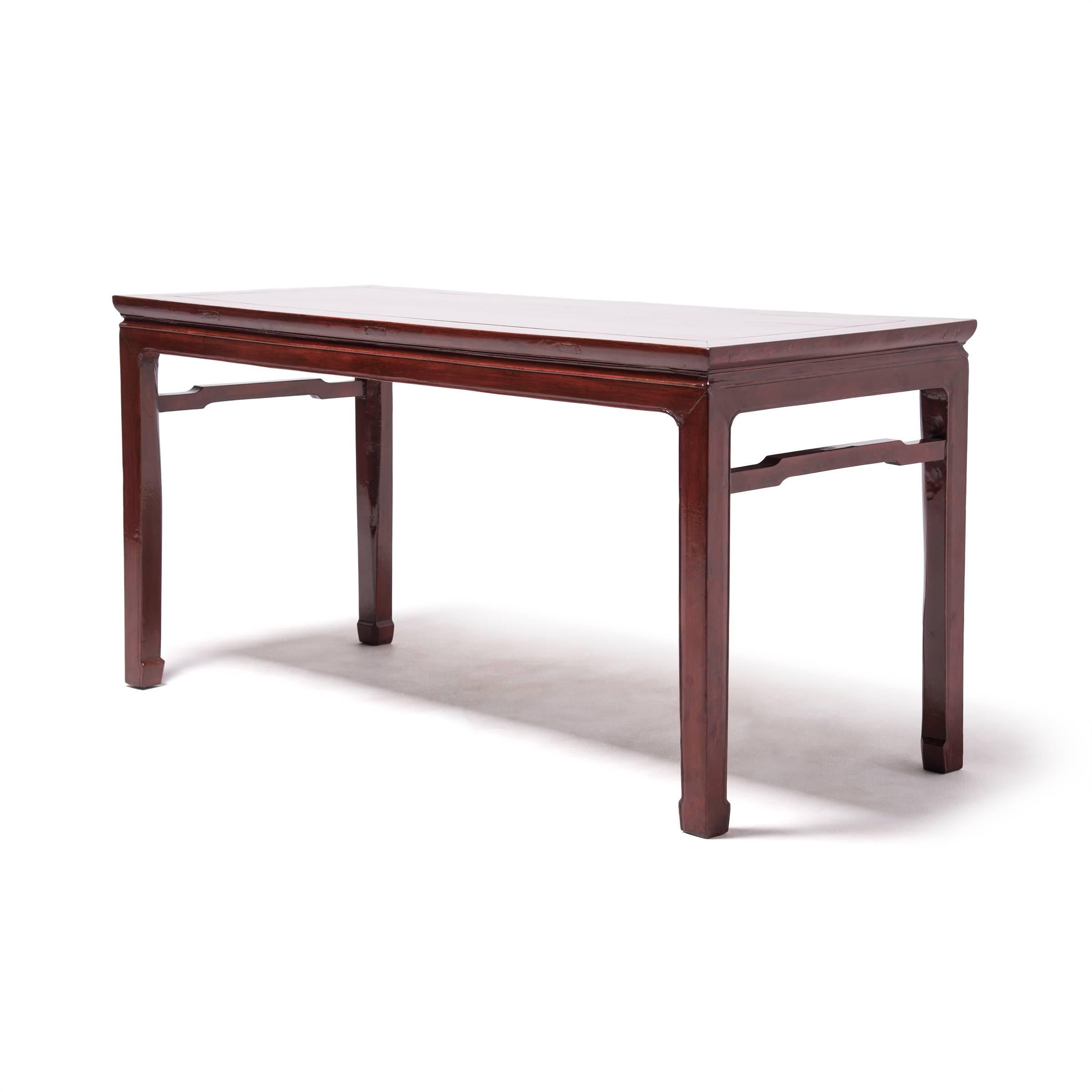 This elegant elmwood painting table was crafted over a century ago by artisans in northern China. The broad tabletop provided an ideal surface for unfurling a scroll to compose poetry or calligraphy paintings. The table is beautifully proportioned