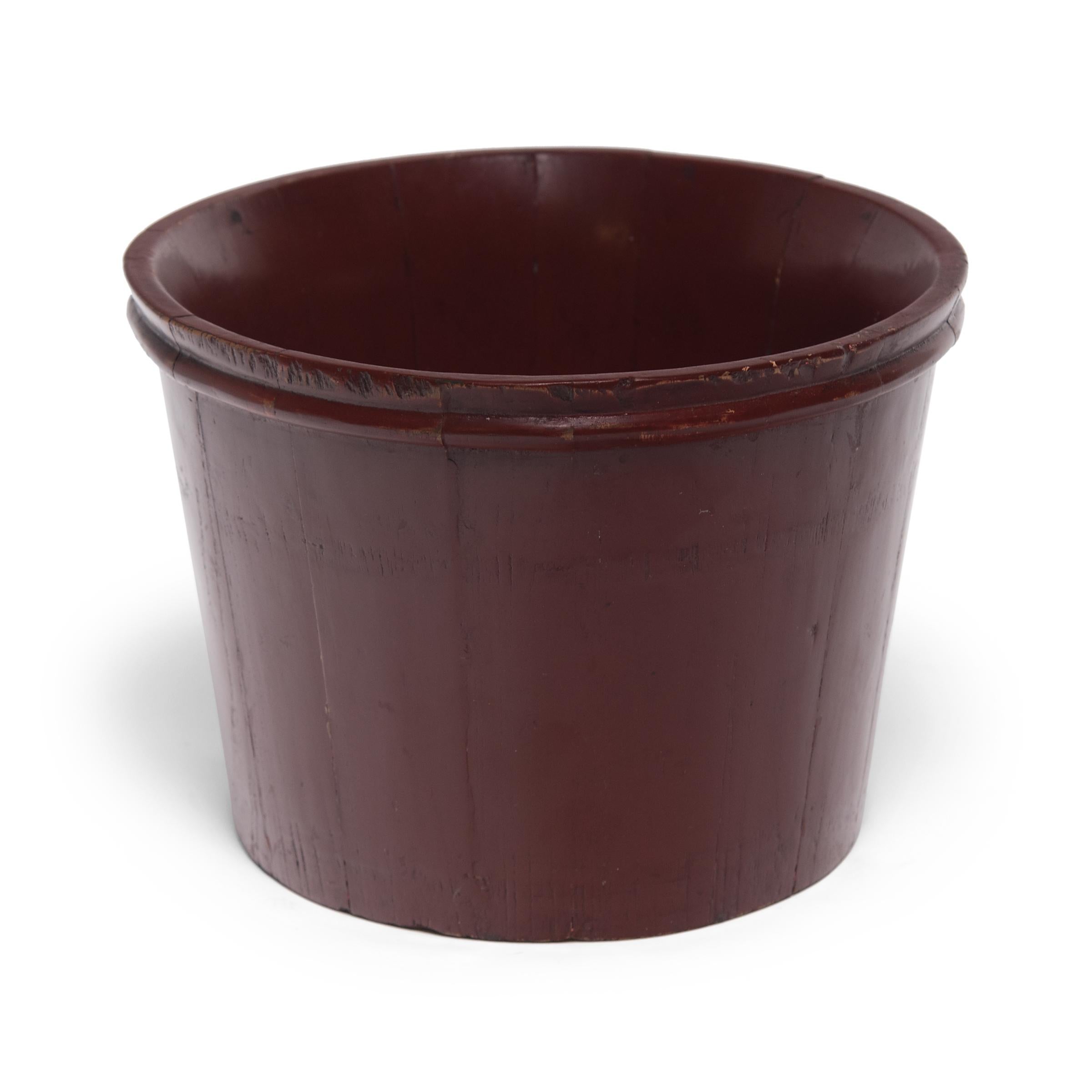 Layers and layers of glossy red lacquer render this water pail made of pine slats nearly seamless, giving it a sleek, burnished appearance. Once used to tote water, we find the vessel's timeless form and rich patina the perfect planter for lush