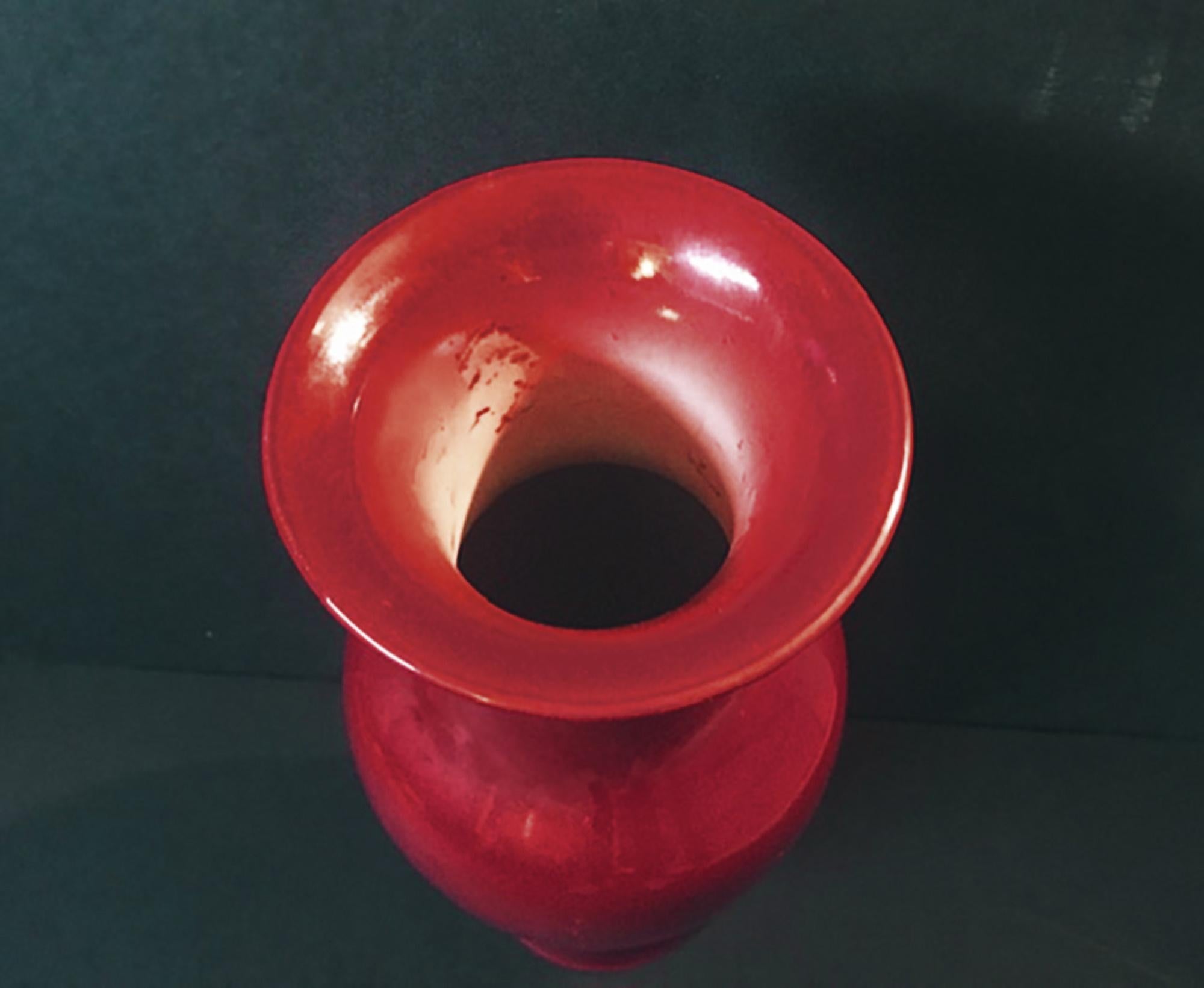 Early 20th century Chinese red porcelain Sang de Boeuf Oxblood vase

This large and elegant 19th century Chinese flambe oxblood vase has a deep copper red monochrome glaze. The glassy red color fades to light just under the lip. The baluster shaped