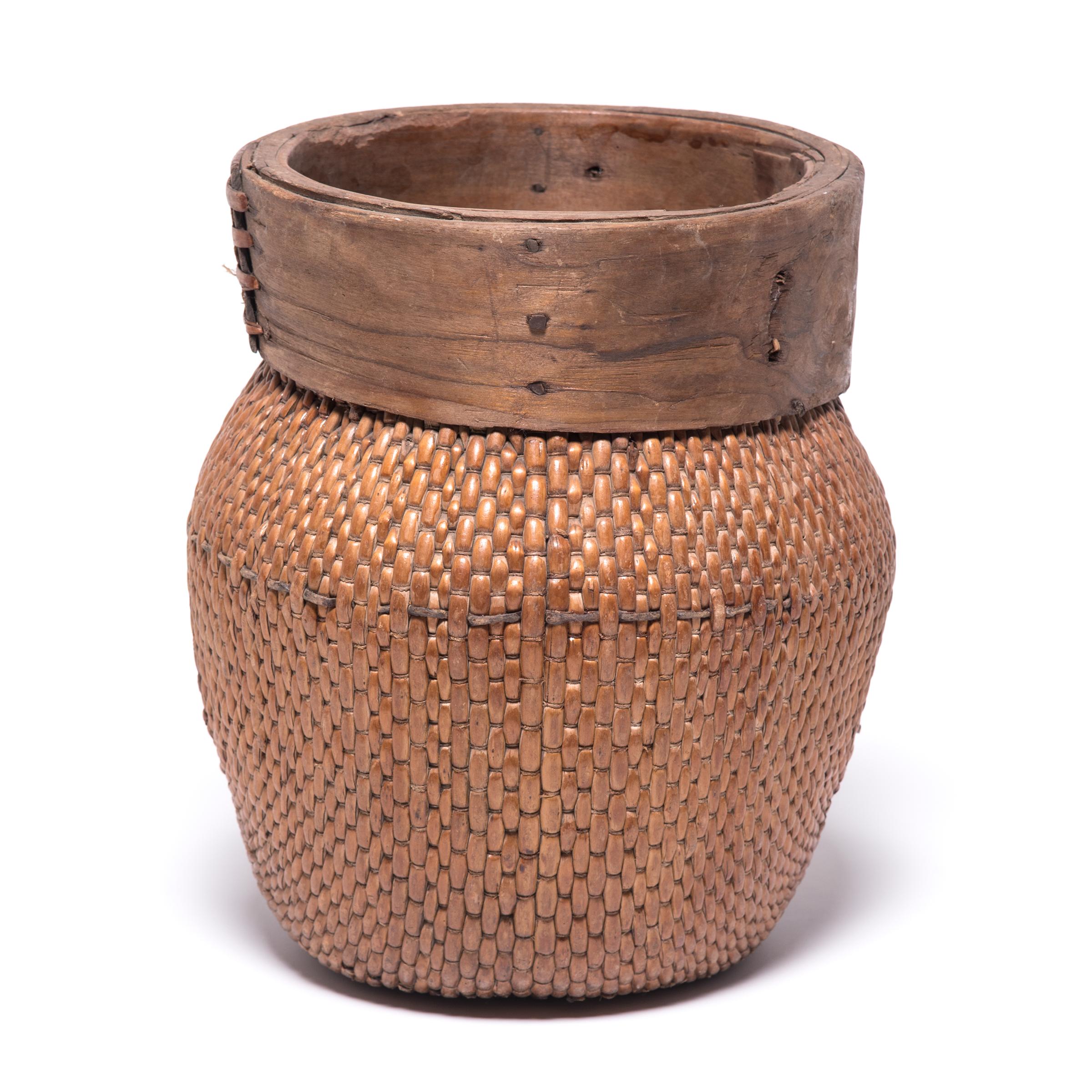 Centuries ago, a reed fisherman’s basket like this one would have been fairly common in rural China: an everyday item that would have been used until it was worn through. This particular example remains in beautiful condition, and so a century