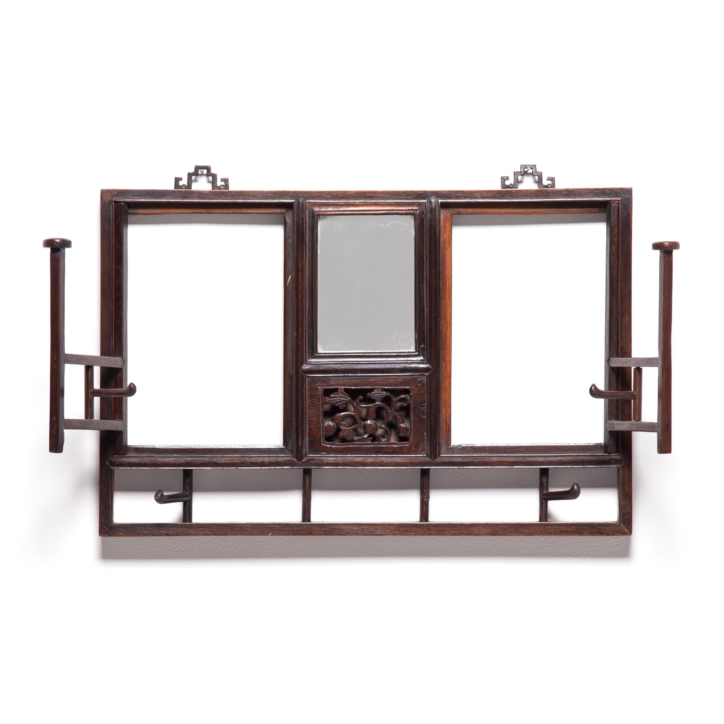 Hung on the wall of a Qing-dynasty home in northern China, this remarkably crafted hat rack provided the kind of elevated display that status-enhancing hats demanded. Beneath the central, compact mirror is an intricately carved hardwood panel of