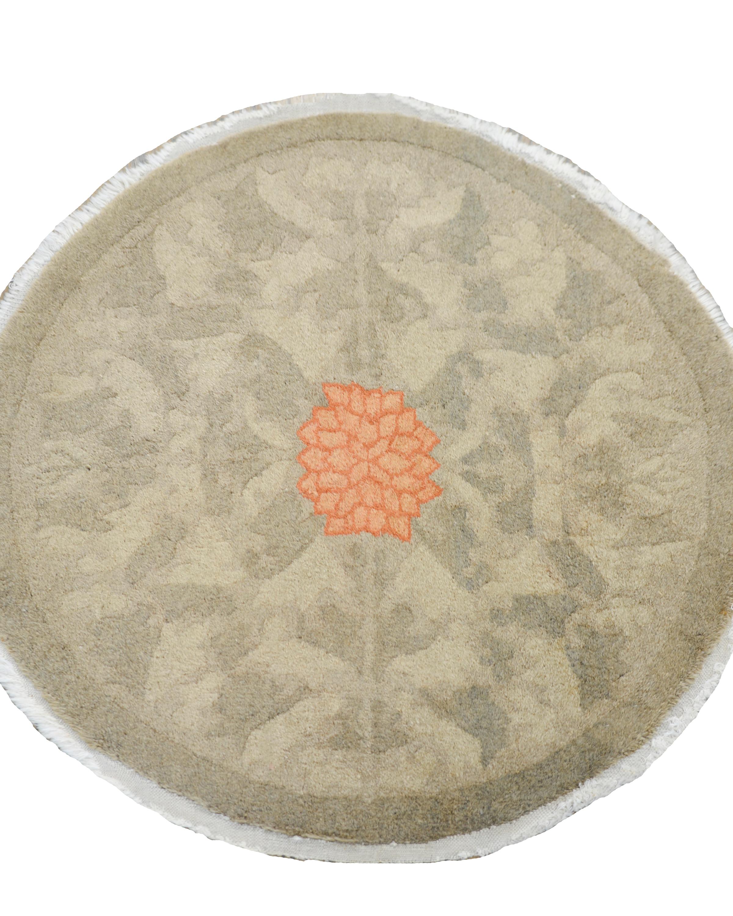 A wonderful early 20th century Chinese round rug with a central pink chrysanthemum amidst a tone-on-tone leaf and vine field.