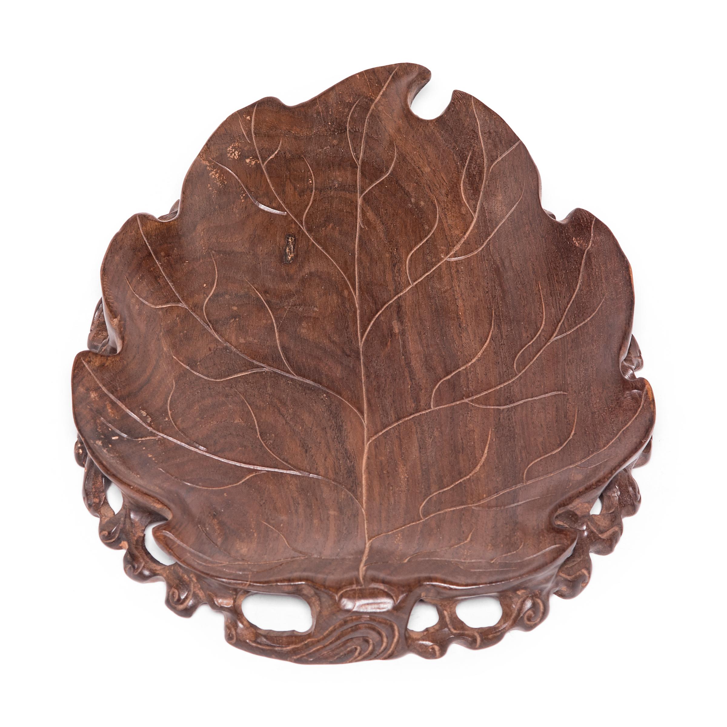 Beautifully hand carved of a fine hardwood, this early 20th century plate once held precious objects or scholar's implements in an artist's studio. Prized for its rich color and fine grain, the wood is on full display in this exquisite tray, a work