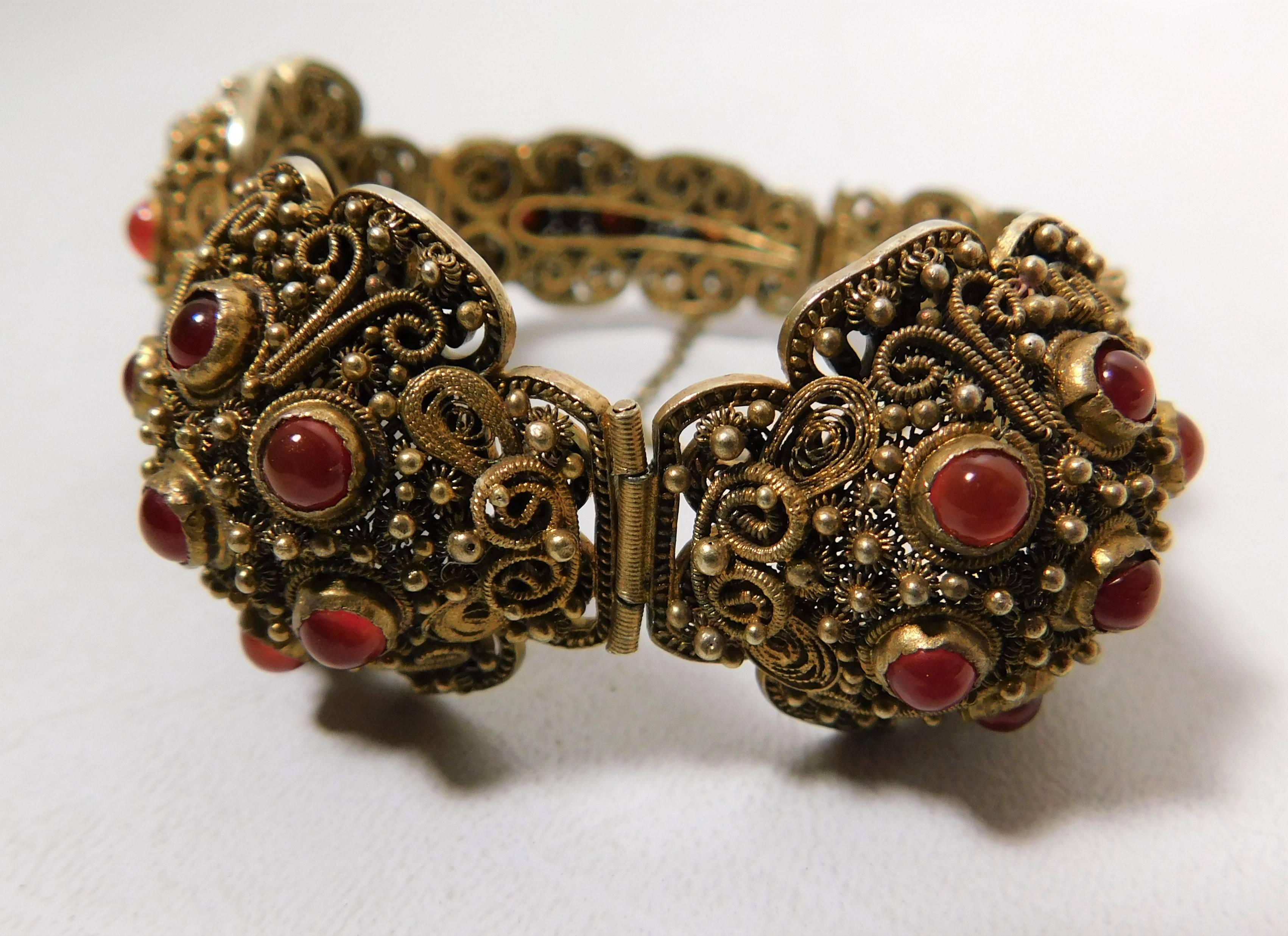 This early 20th century Chinese vermeil bracelet has 26 carnelian or pink coral stones.