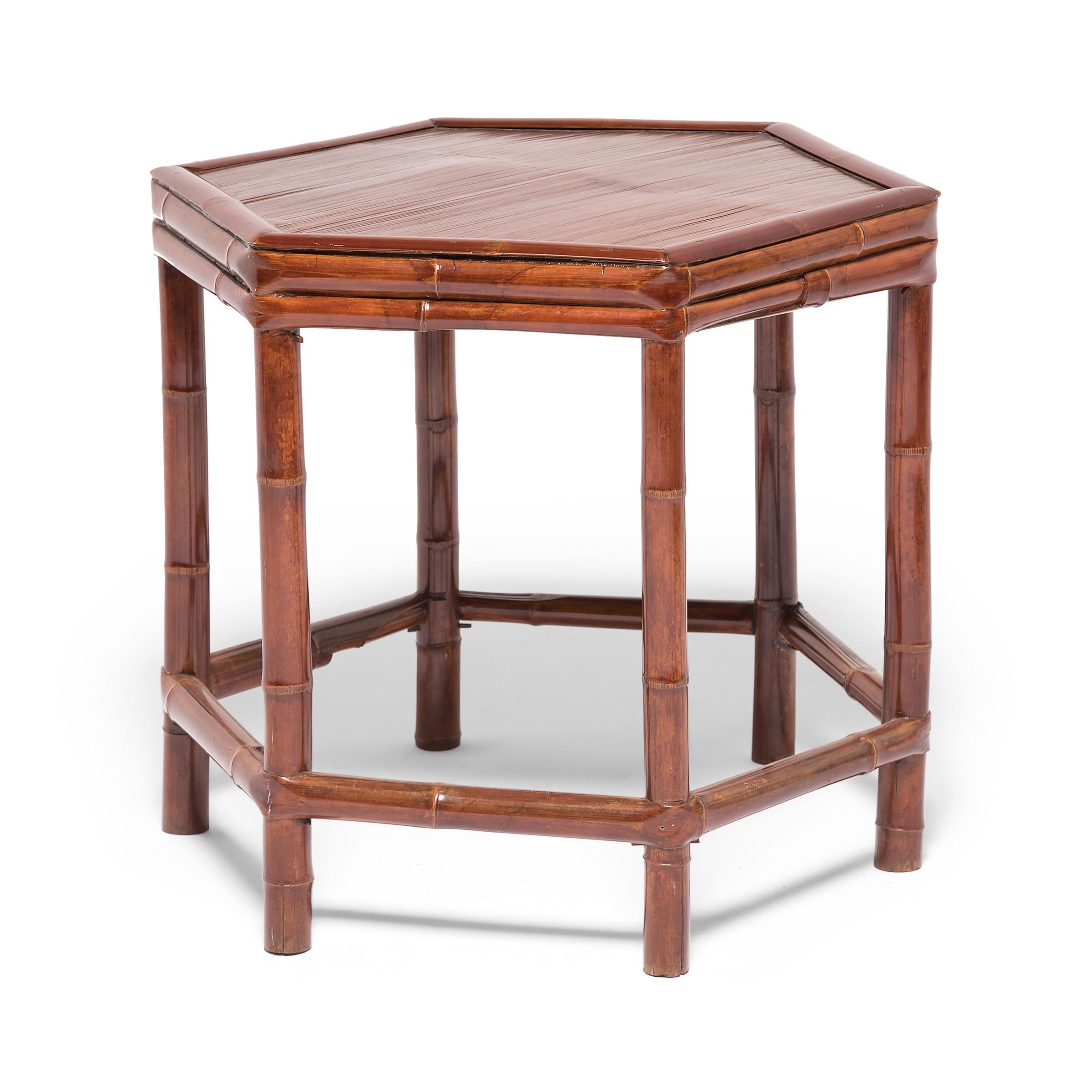The six-sided shape of this early 20th-century table from southern China is unusual for Qing-dynasty furniture. Referencing the simpler designs popular in previous eras, this side table was constructed with a frame of bent bamboo and a crushed