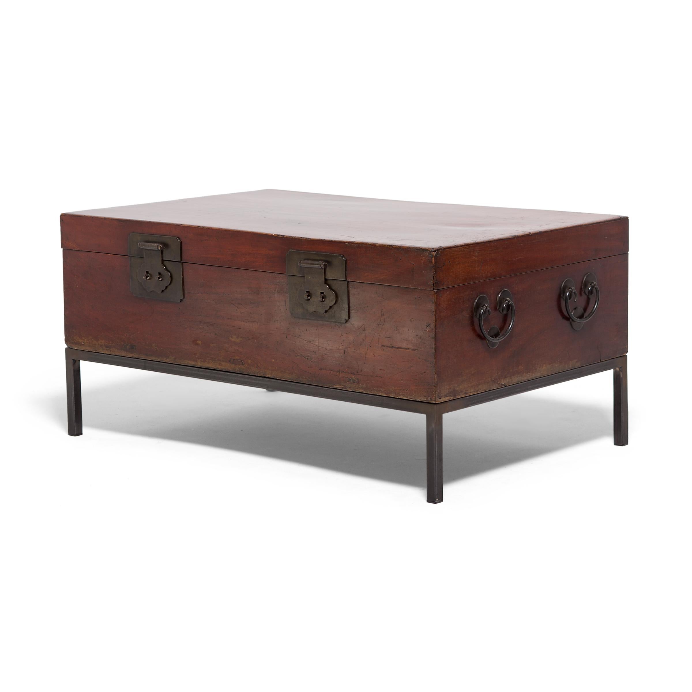 Cloud-shaped latches adorn this camphor wood trunk from the turn of the century. Camphor is prized not only for its beautiful grain and rich color, but also for its aromatic nature and its remarkable ability to keep its contents, such as knits or