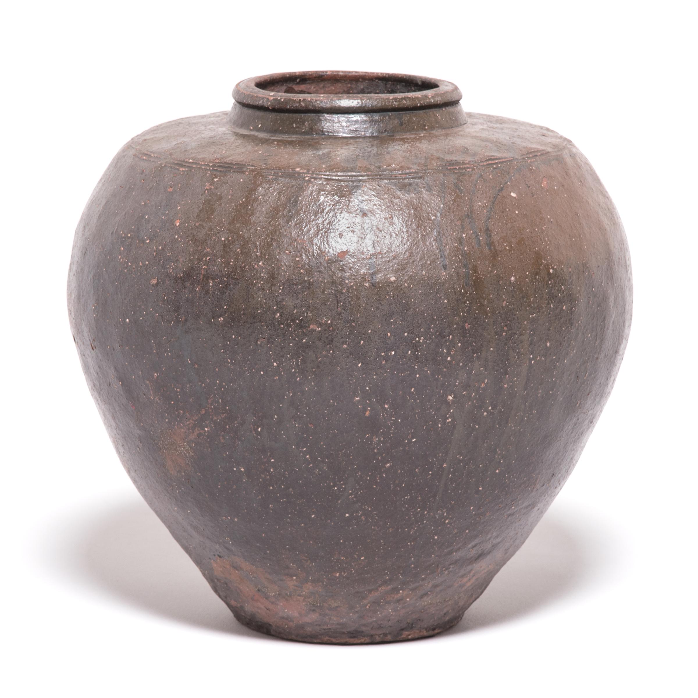 The shape of this handmade ceramic jar from Northern China dates back to the Bronze Age c. 3000 BC, when it was used to store wine and spirits made from rice and grains. It has wonderful organic color, form, and balance.

Additional