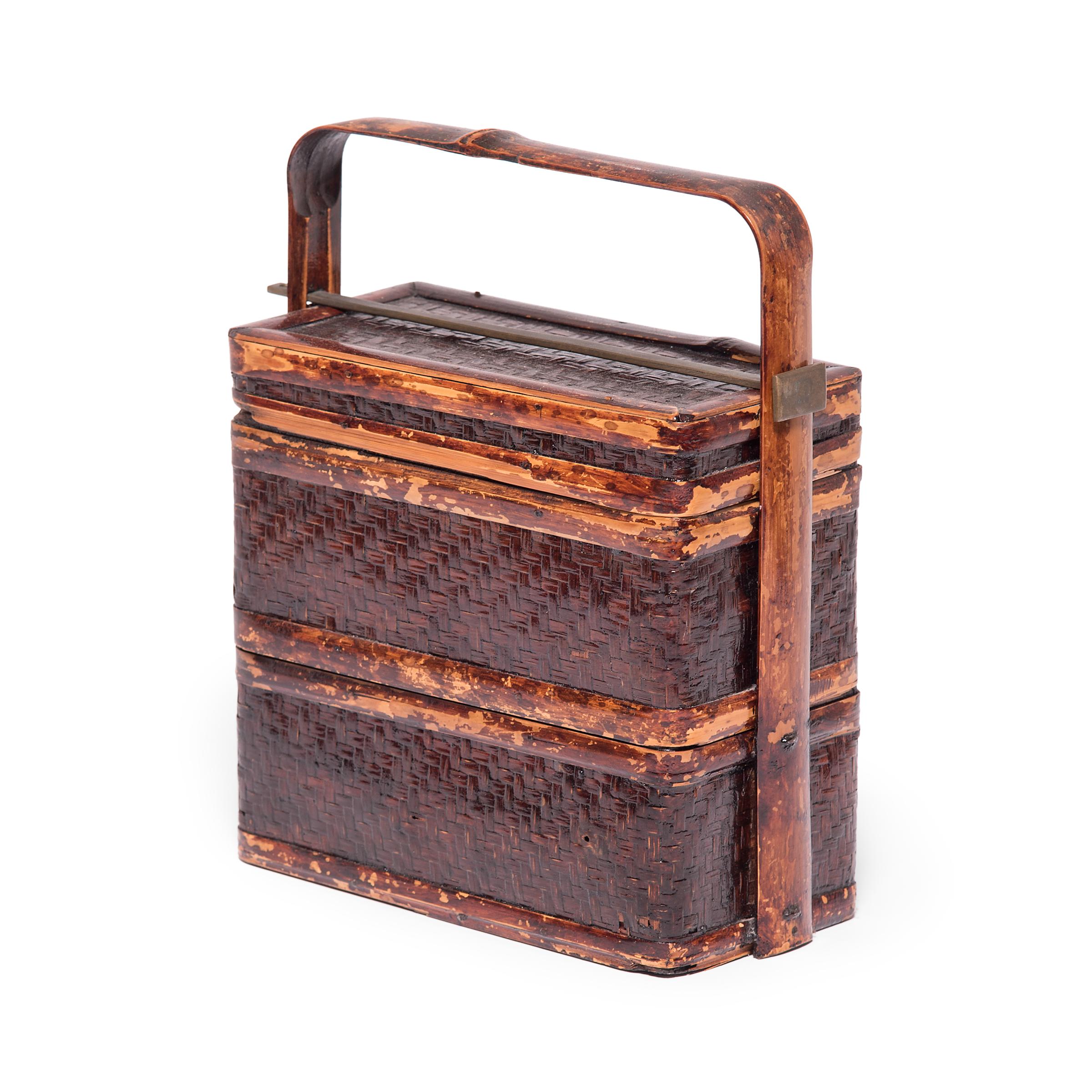 The basic form of this three-tiered box with handle has remained unchanged for a thousand years. Used like the modern lunchbox, each tier of this portable stacking box would have been filled with food and carried around by the handle. Unlike