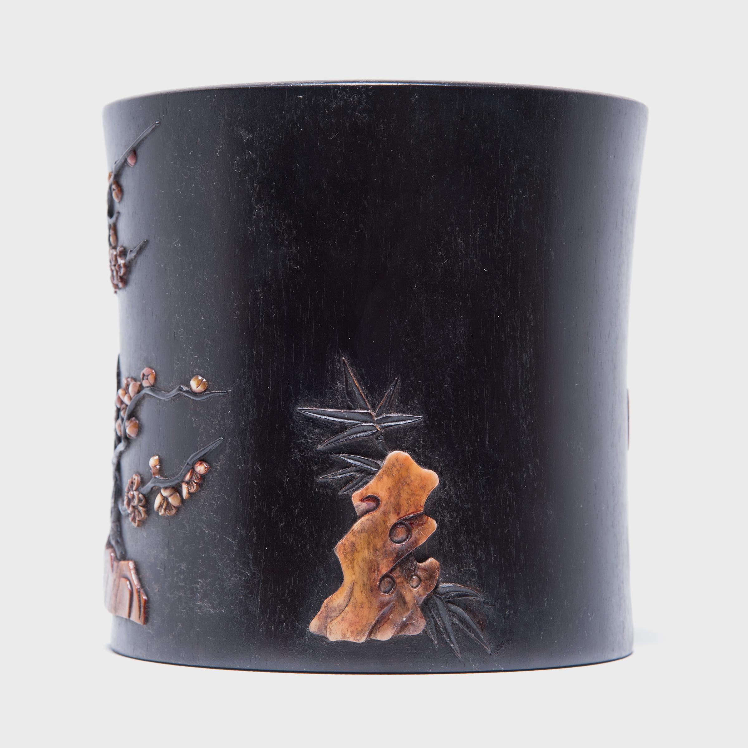 A brush pot or bitong, such as this one, was often found among a scholar’s brushes, inkpot, and inkstone. This beautiful example is carved from zitan, a highly prized rare and slow-growing hardwood. Mother of pearl and soapstone inlays embellish the