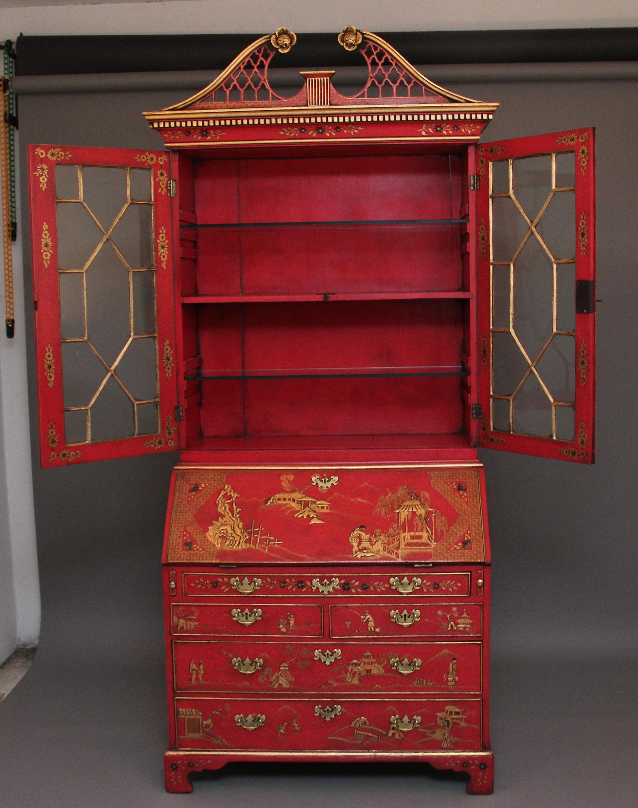 An impressive chinoiserie bureau bookcase on a red background, the carcass itself 18th century but lacquered in the early 20th century, having a pierced fret swan neck pediment with decorative floral patraes, nice shaped moulded cornice with dentil