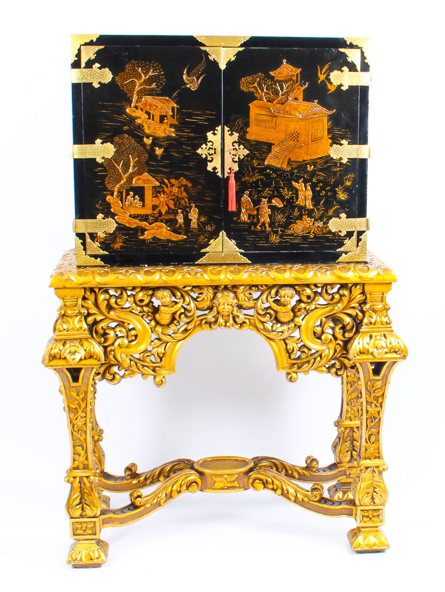 This is beautifully crafted antique 17th century Revival Chinoiserie lacquer cabinet on stand, circa 1900 in date. 

The cabinet features figural scenes to the twin doors and opens to further figures and animals on a red lacquered ground to the