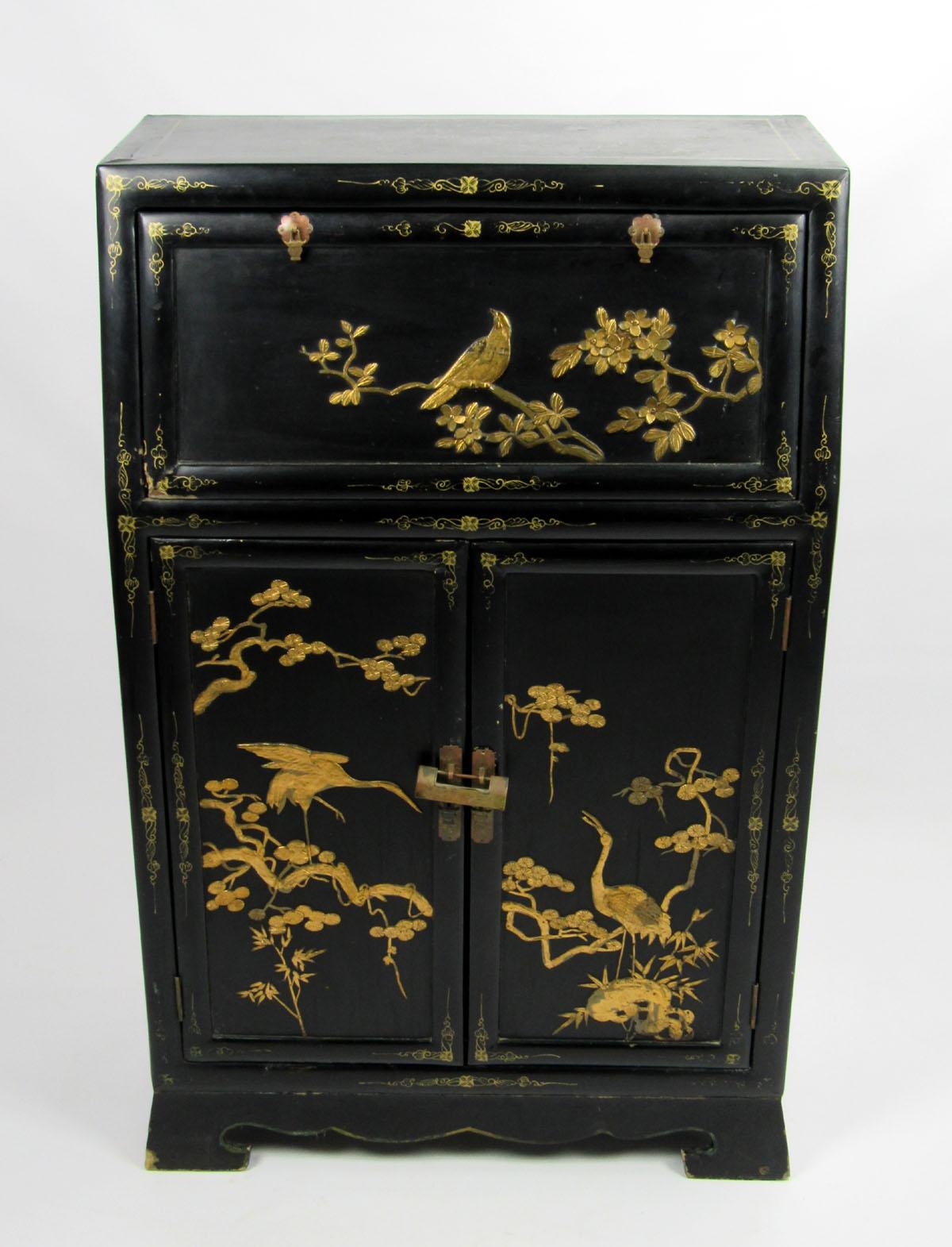 Early 20th century Chinoiserie petite secretary of ebonized wood with gold detail featuring birds and botanical elements.