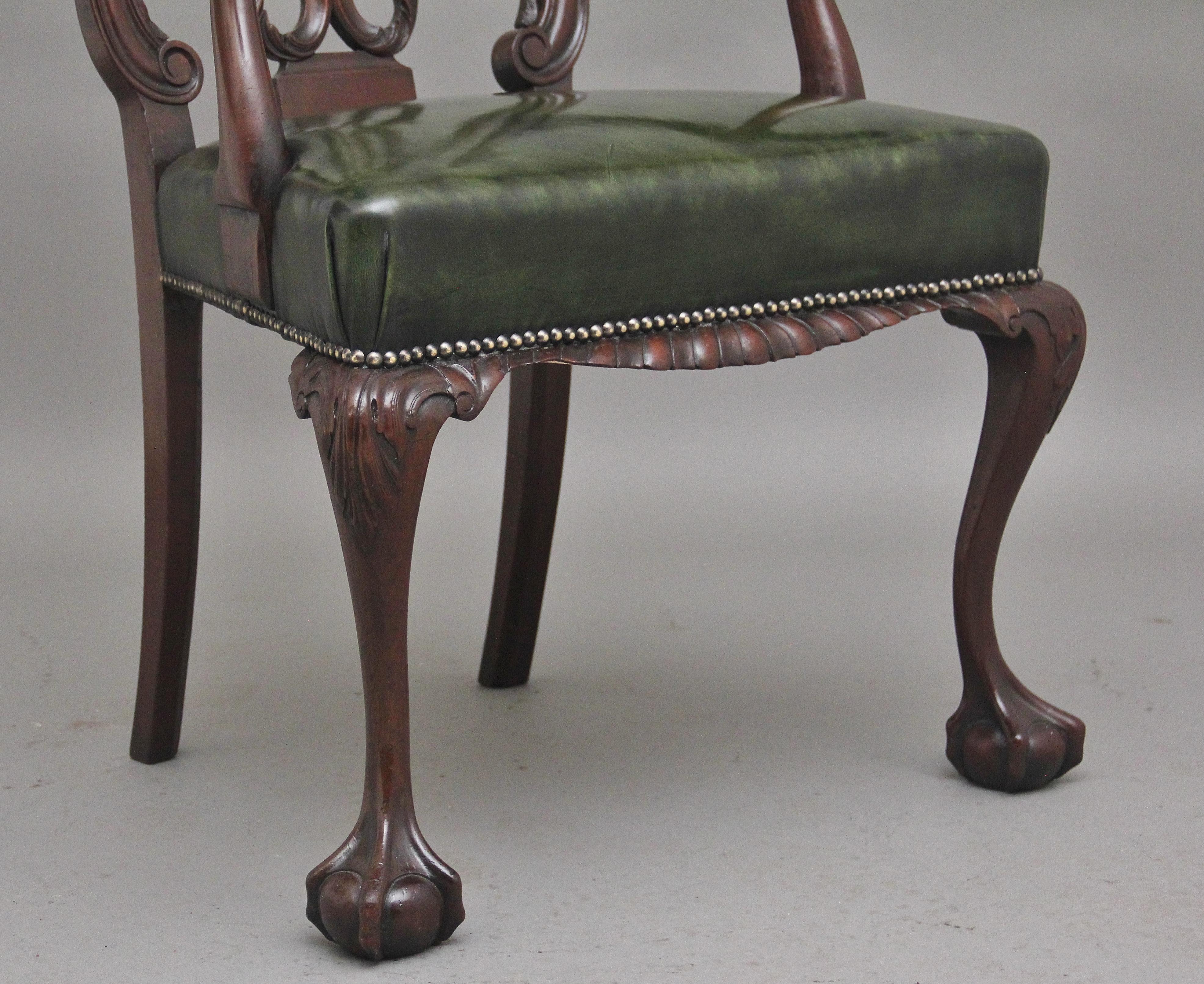 A highly decorative early 20th Century carved mahogany armchair in the Chippendale style, having a wonderfully carved and pierced back splat, the slender curved supports with scroll decoration on the front of the arms, having a re-upholstered